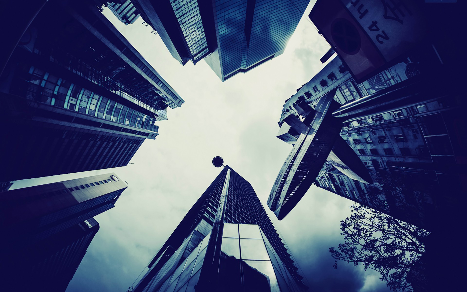 Low angle view of skyscrapers against cloudy sky HD Wallpaper