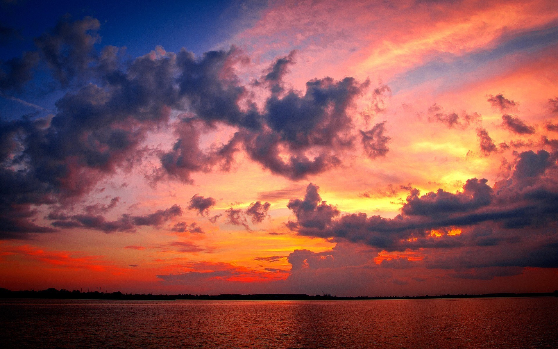Dramatic sunset over a body of water HD Wallpaper