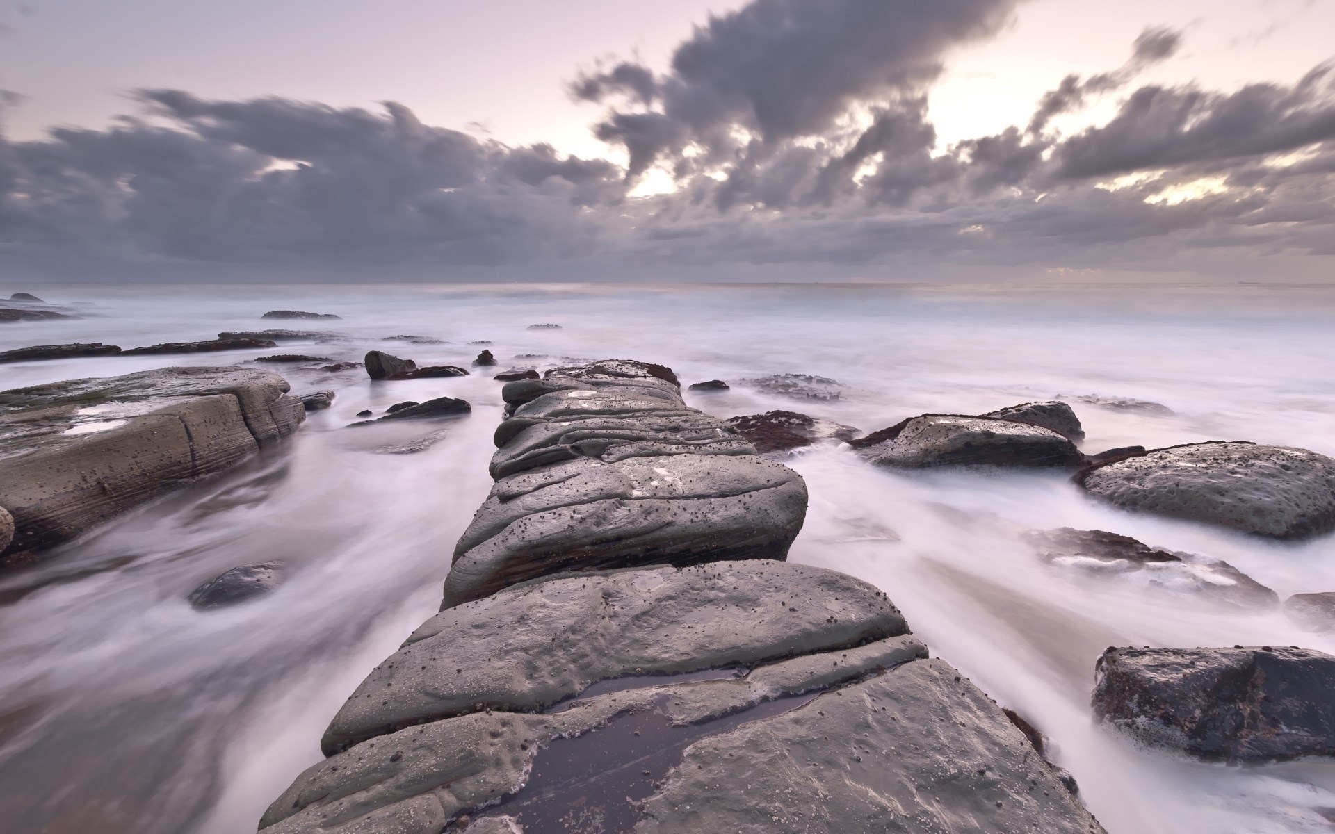 Rocky coastline with waves at sunset HD Wallpaper