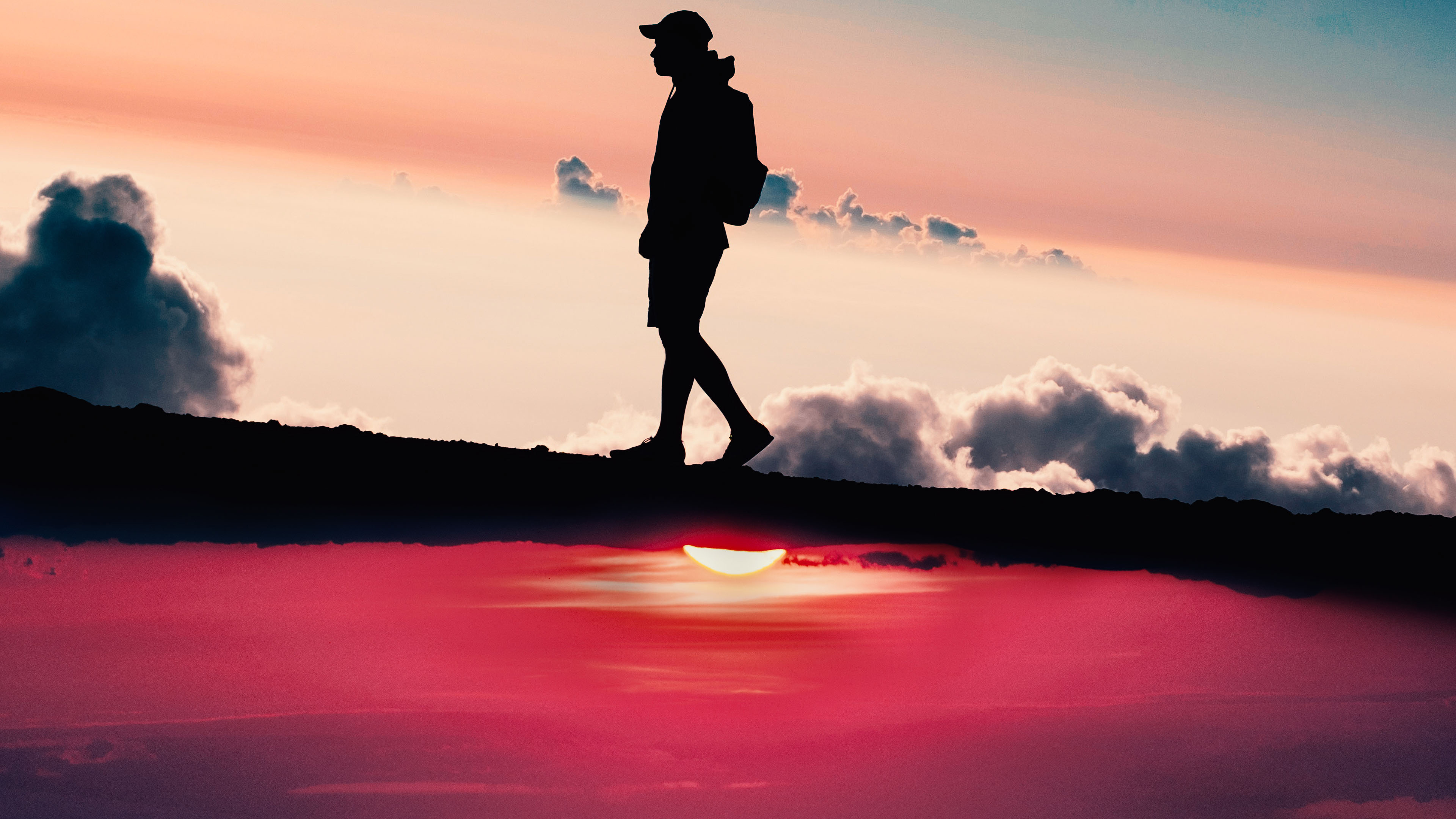Silhouette of a person walking at sunset HD Wallpaper