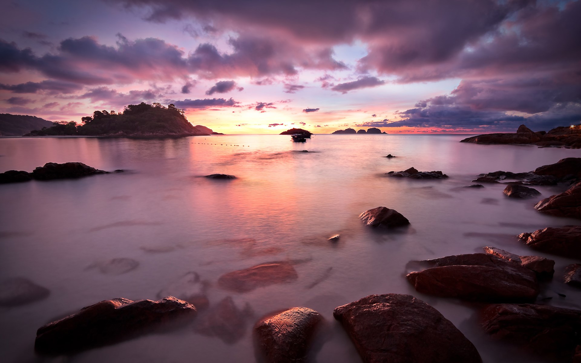 Sunset over a rocky beach with calm water HD Wallpaper