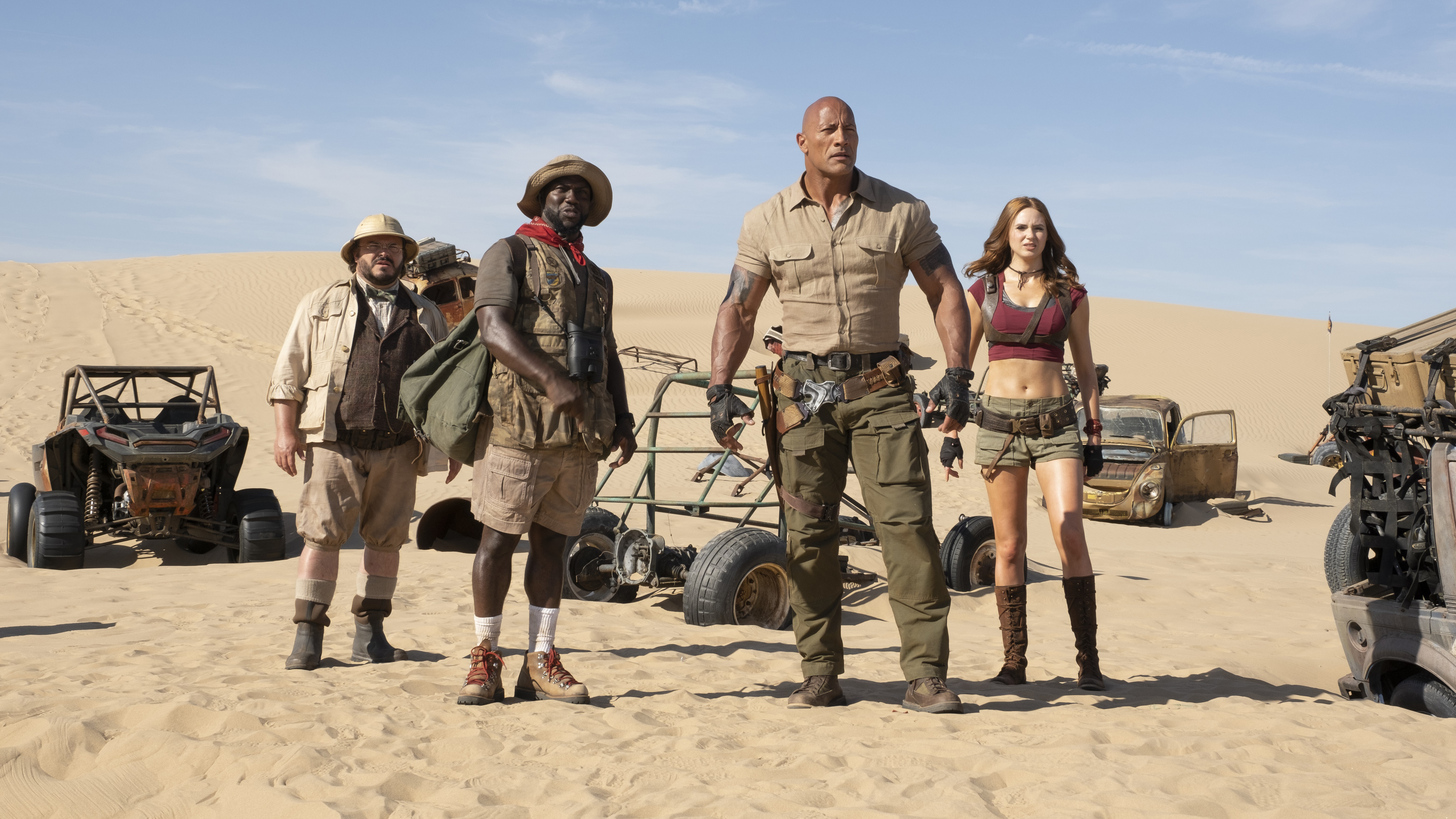Four adventurers in a desert with vehicles HD Wallpaper
