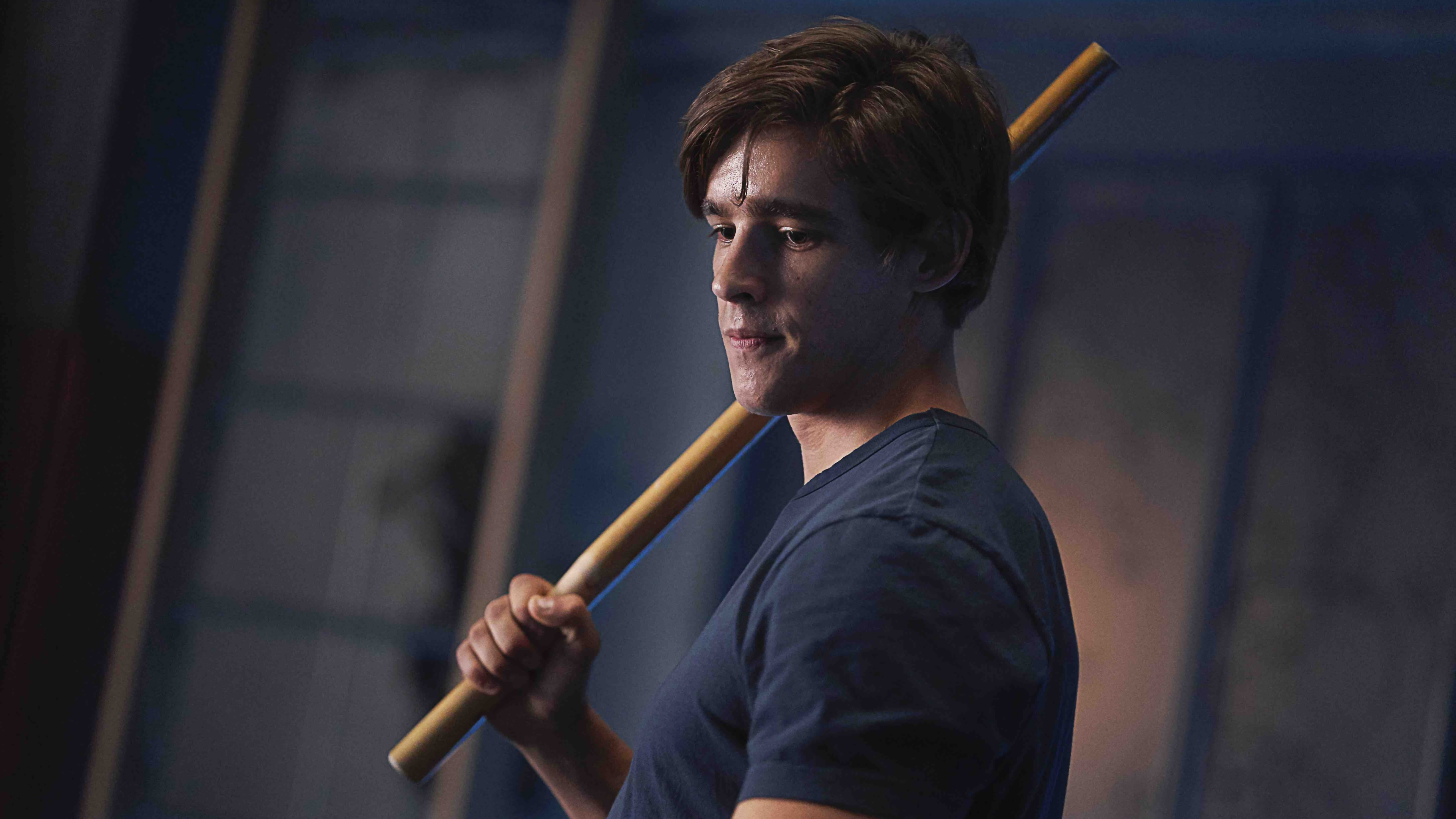Dick Grayson from Titans holding a wooden staff HD Wallpaper