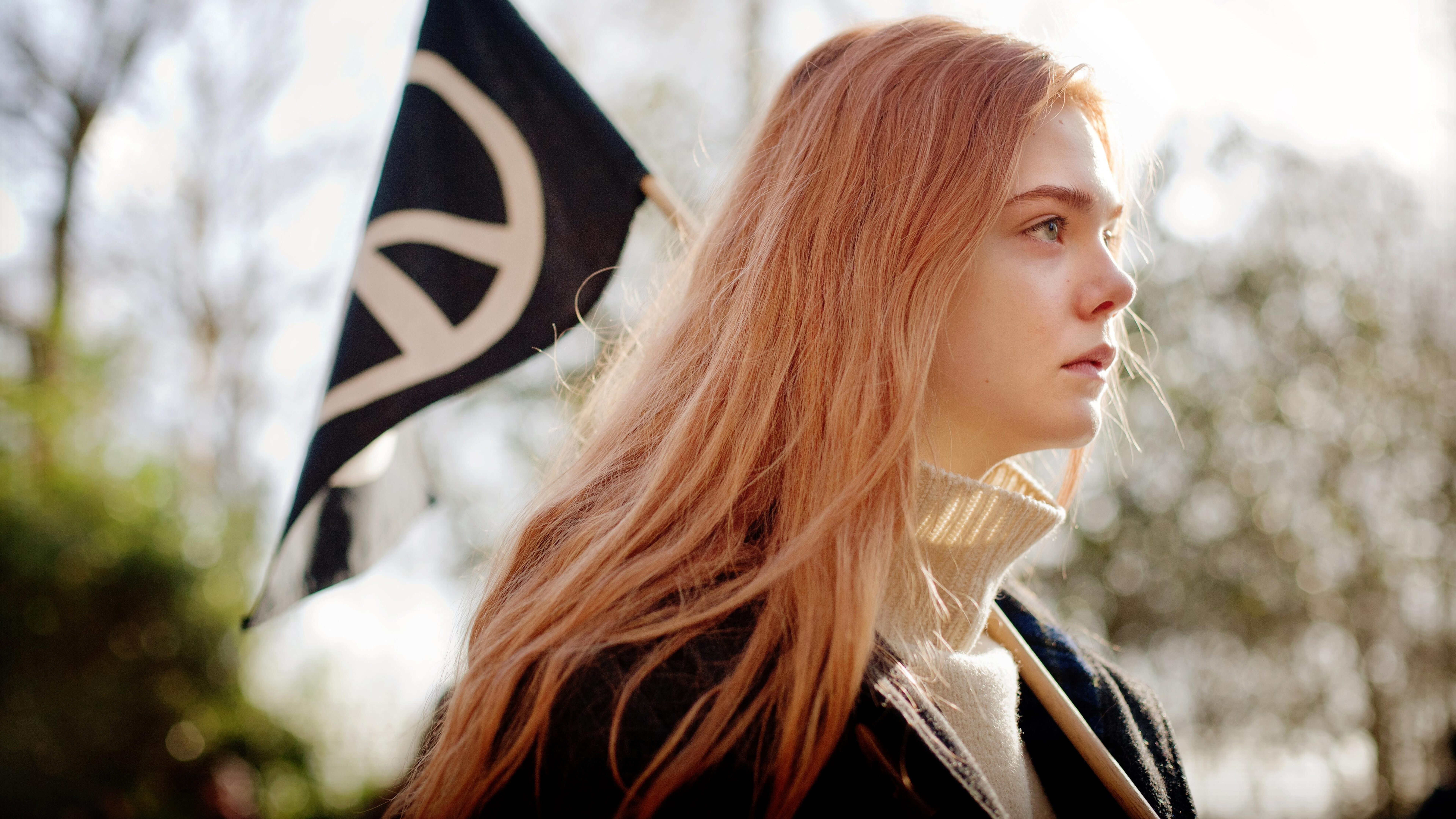 Elle Fanning holding a peace flag HD Wallpaper