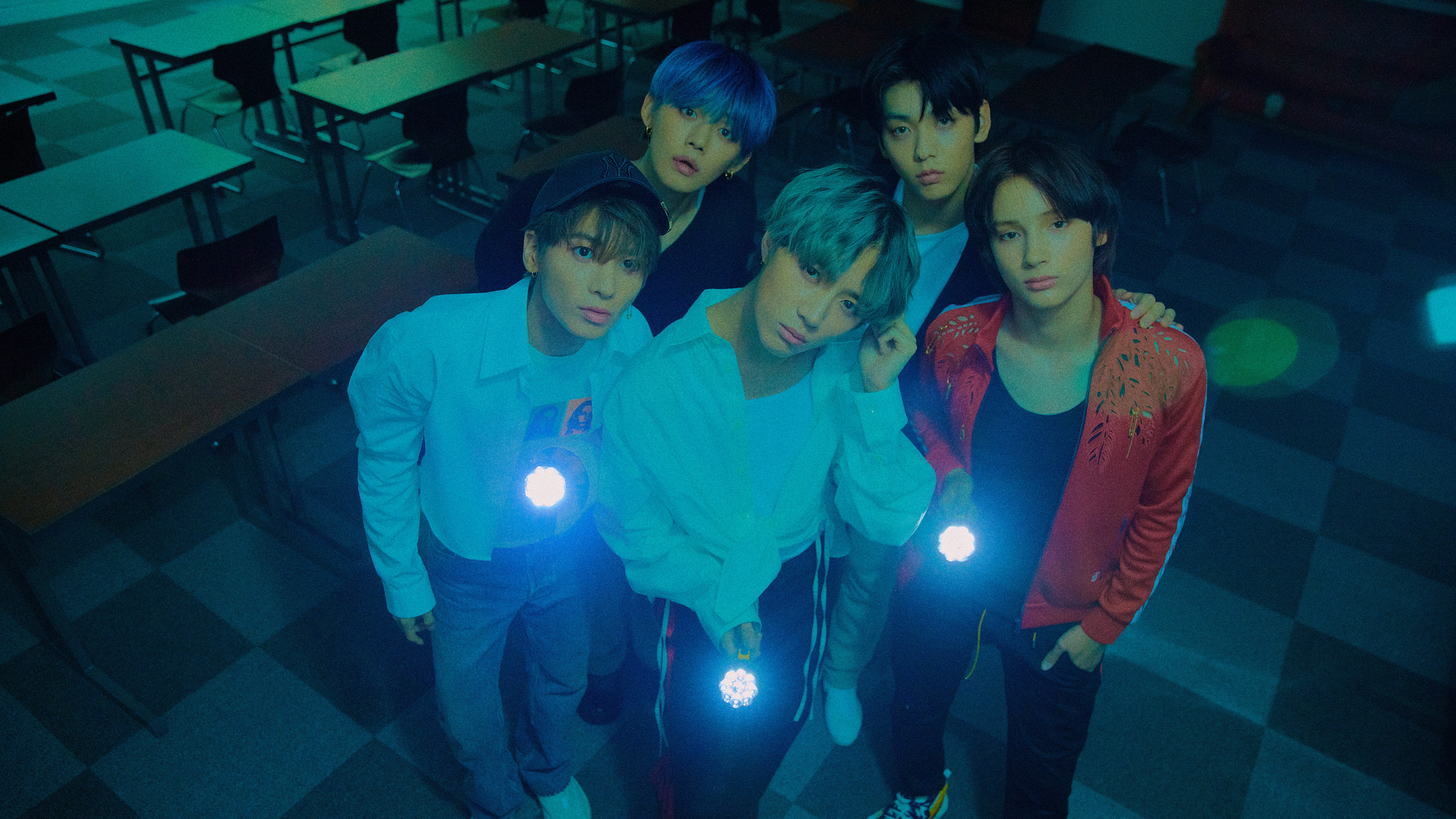 Five young men holding flashlights in a classroom HD Wallpaper