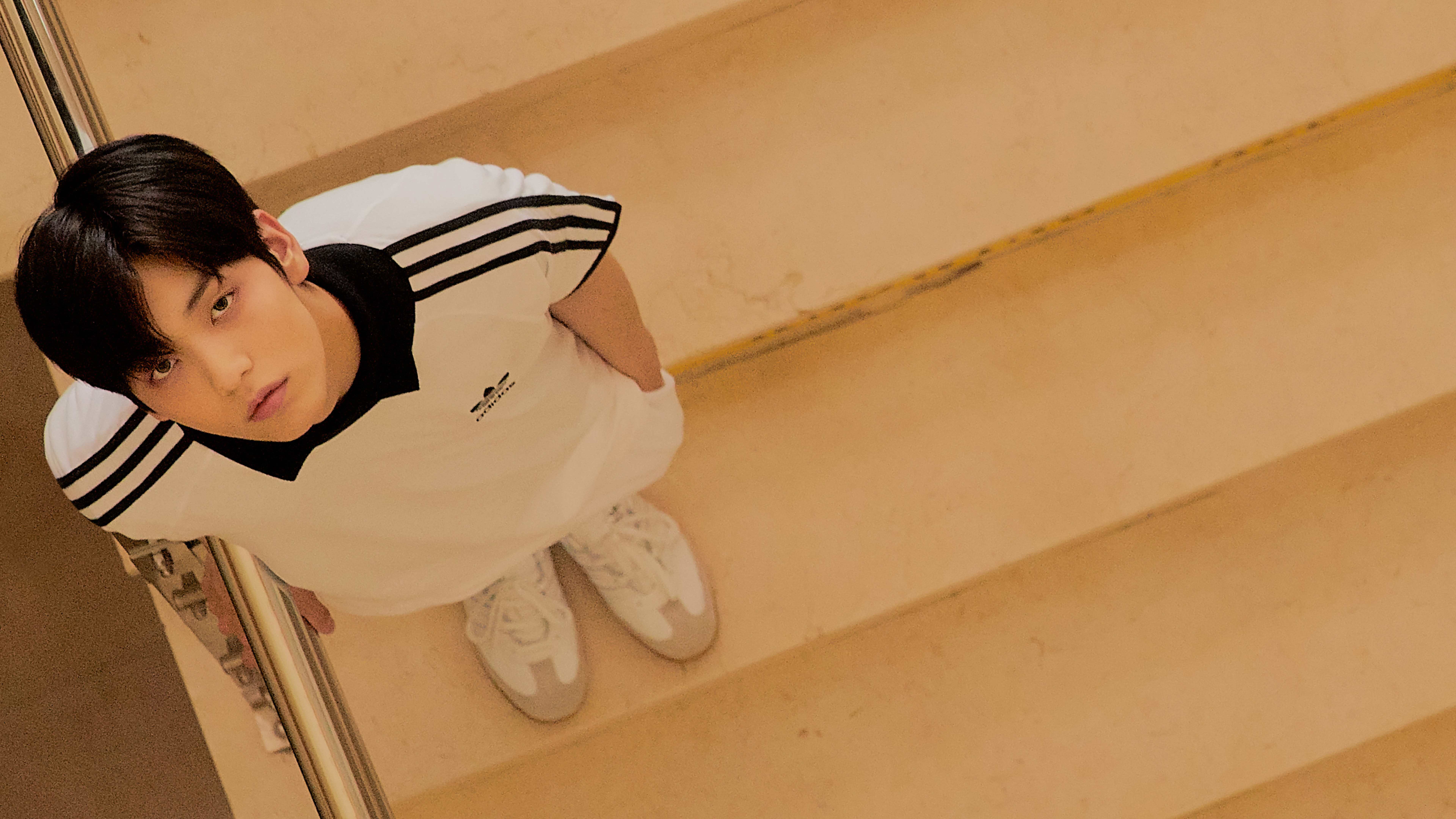 A young man in an Adidas tracksuit on stairs HD Wallpaper