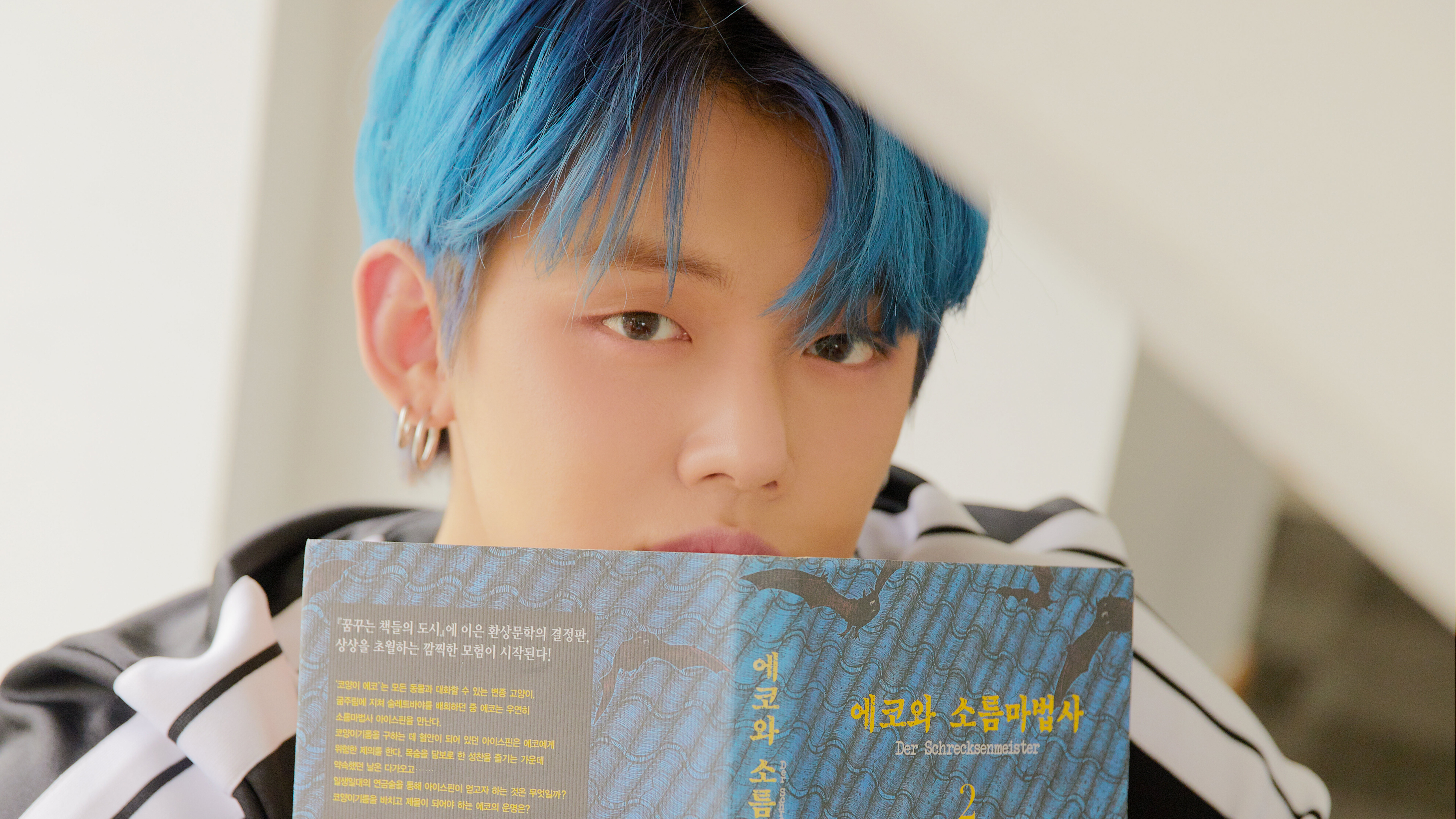 Yeonjun from TXT holding a book HD Wallpaper