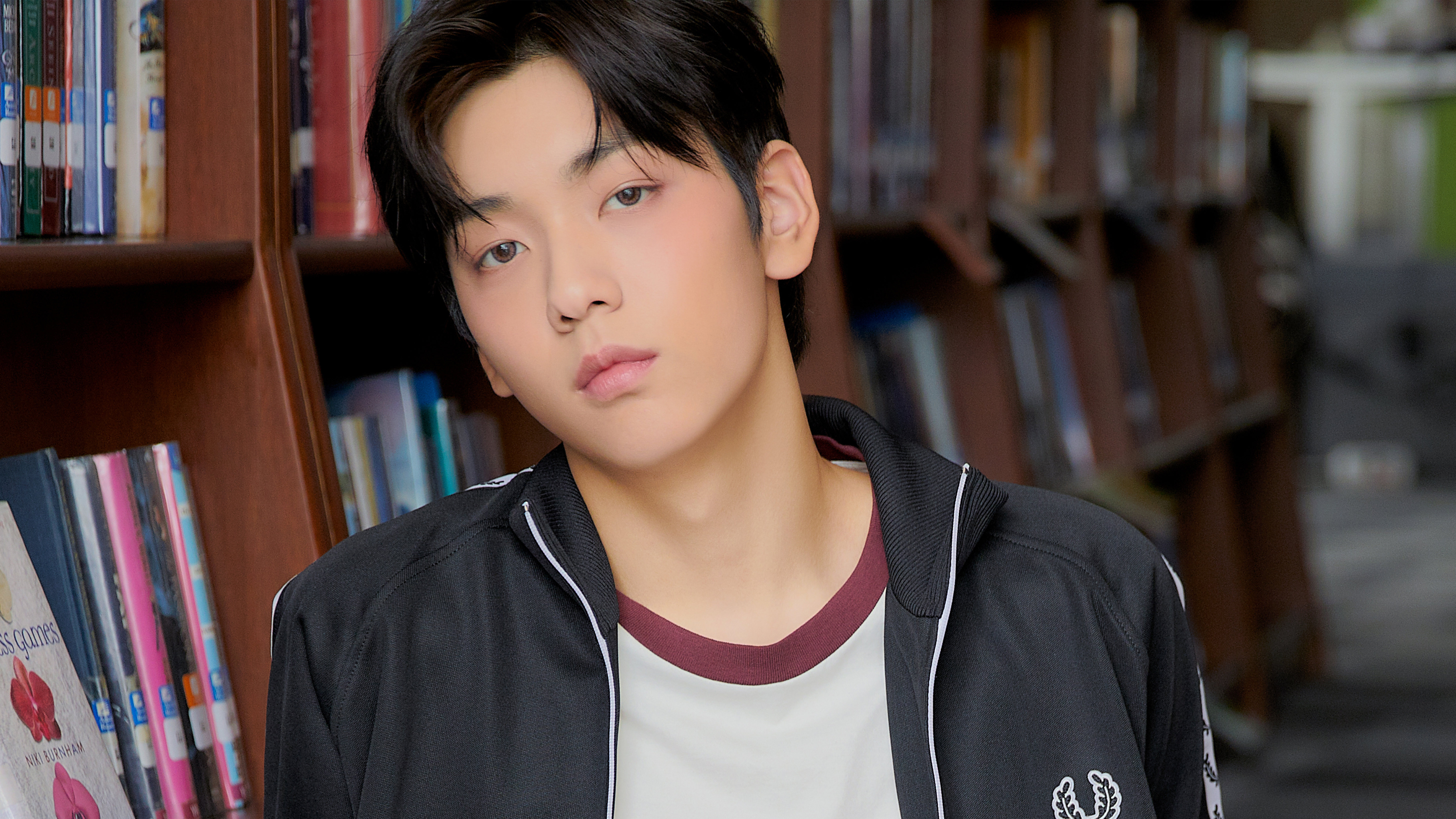 A young man in a library HD Wallpaper
