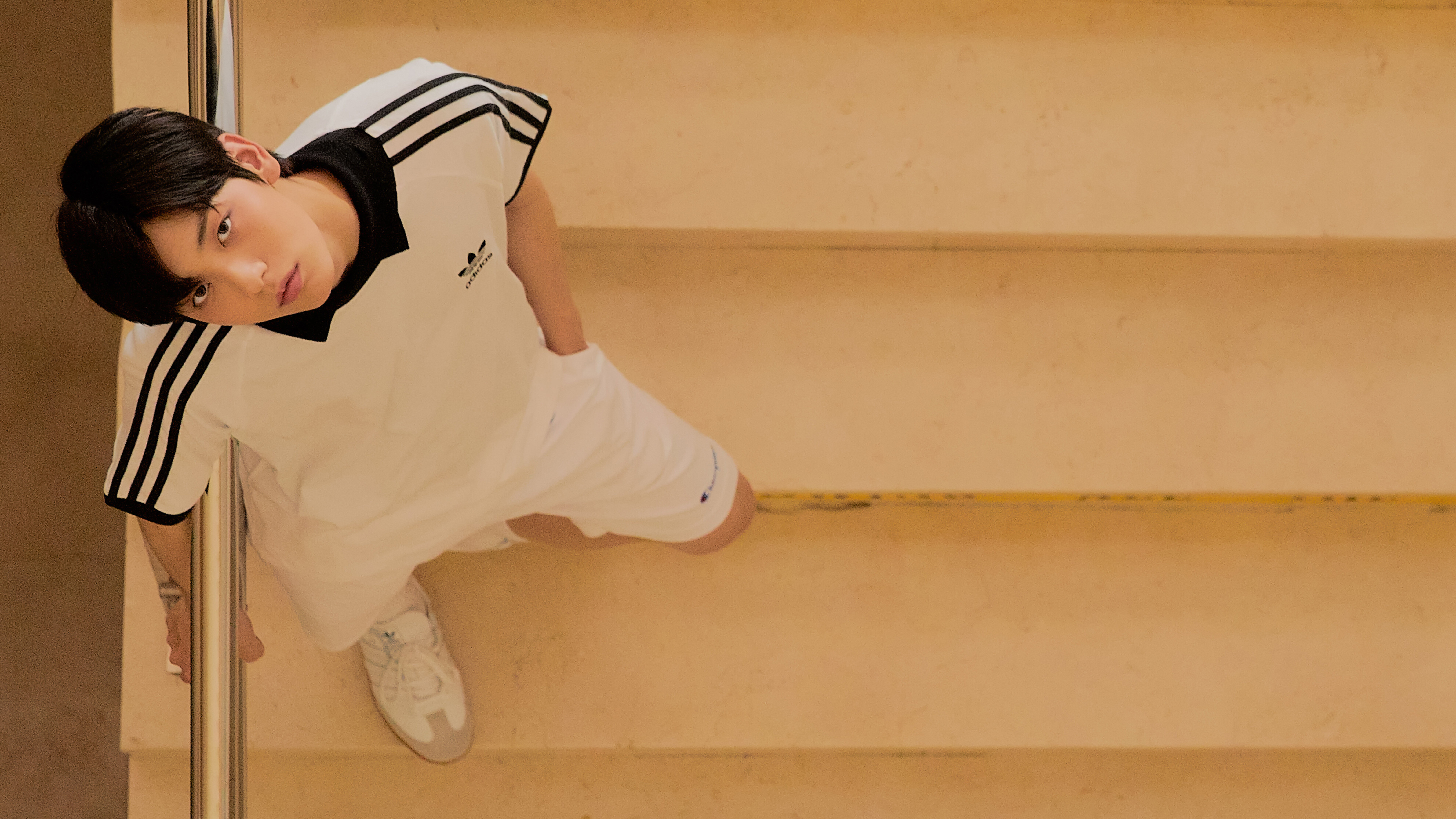 Young man in Adidas outfit on stairs HD Wallpaper