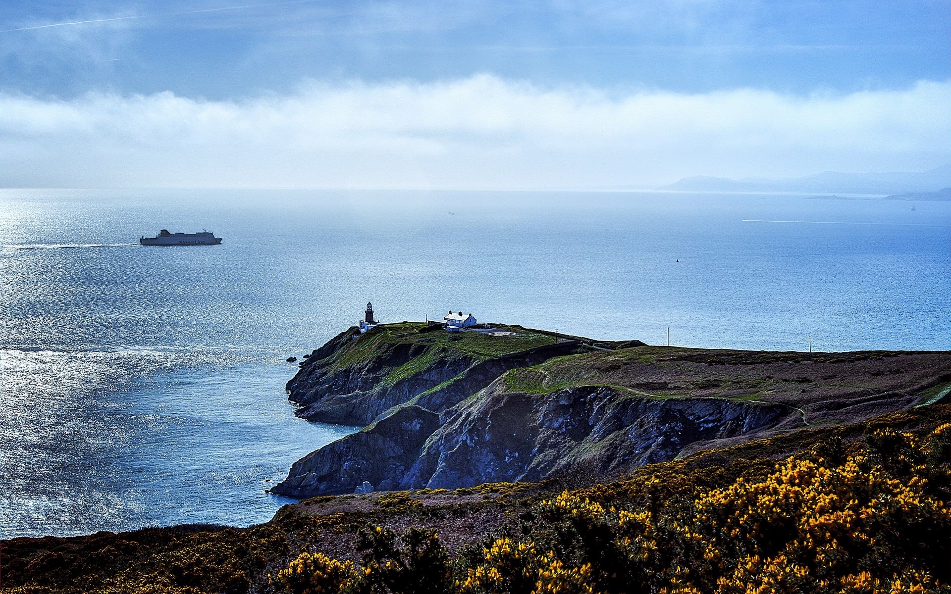 Ferry and lighthouse on a cliff overlooking the sea HD Wallpaper
