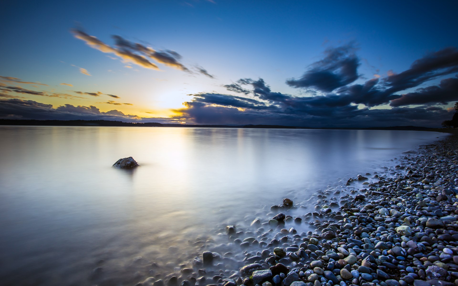 Long exposure of a rocky shore at sunset HD Wallpaper