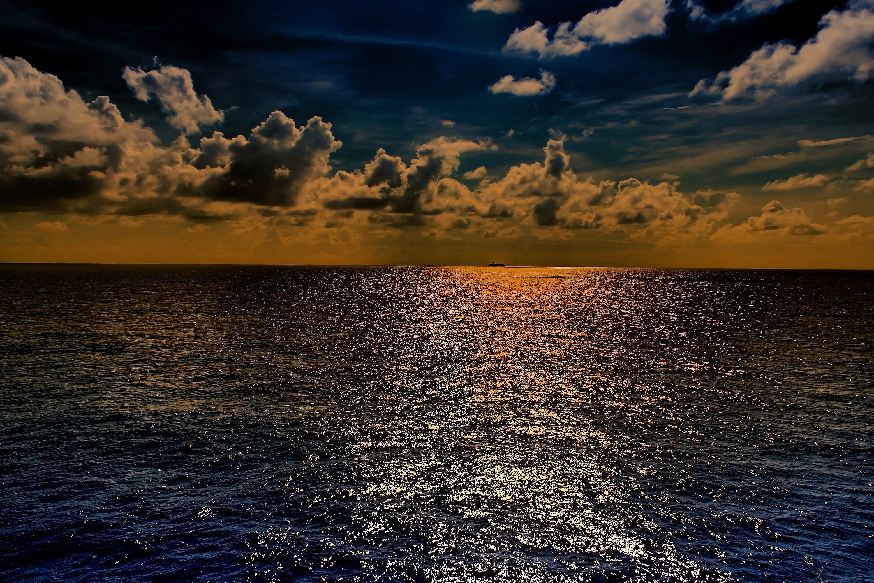 Ship on the ocean at sunset with dramatic clouds HD Wallpaper