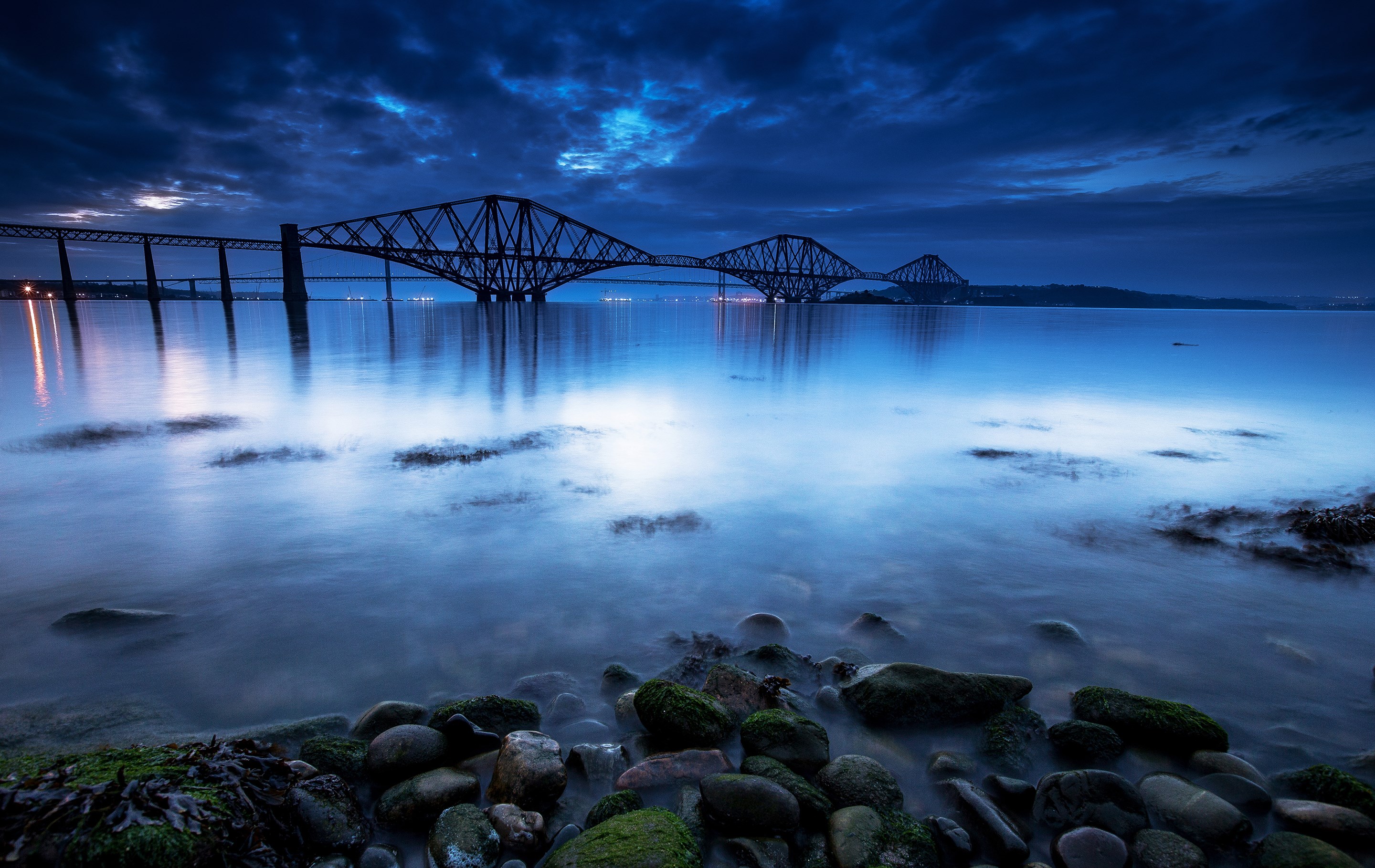 Forth Bridge at dusk over calm water HD Wallpaper
