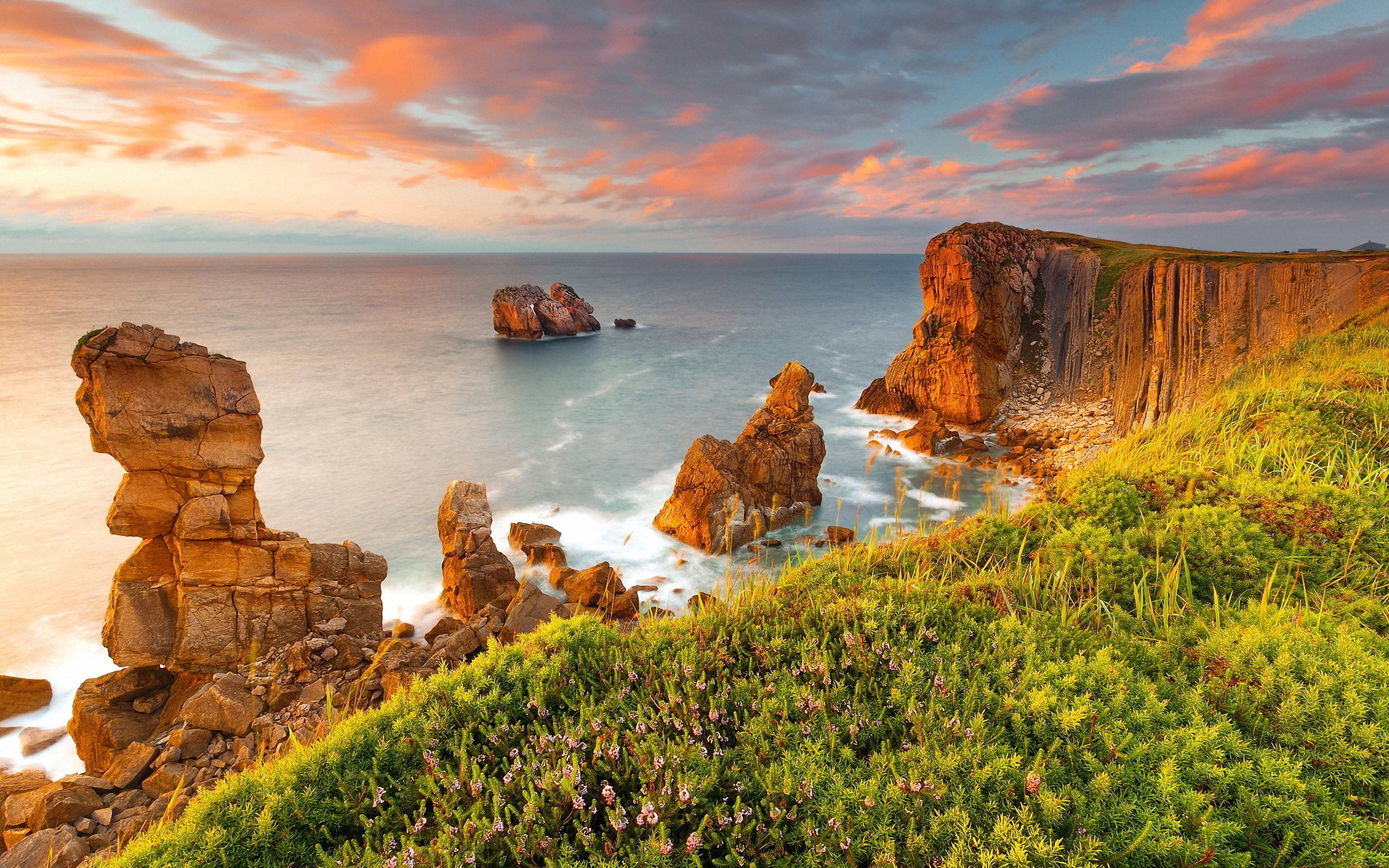 Rocky coastline with sea stacks at sunset HD Wallpaper