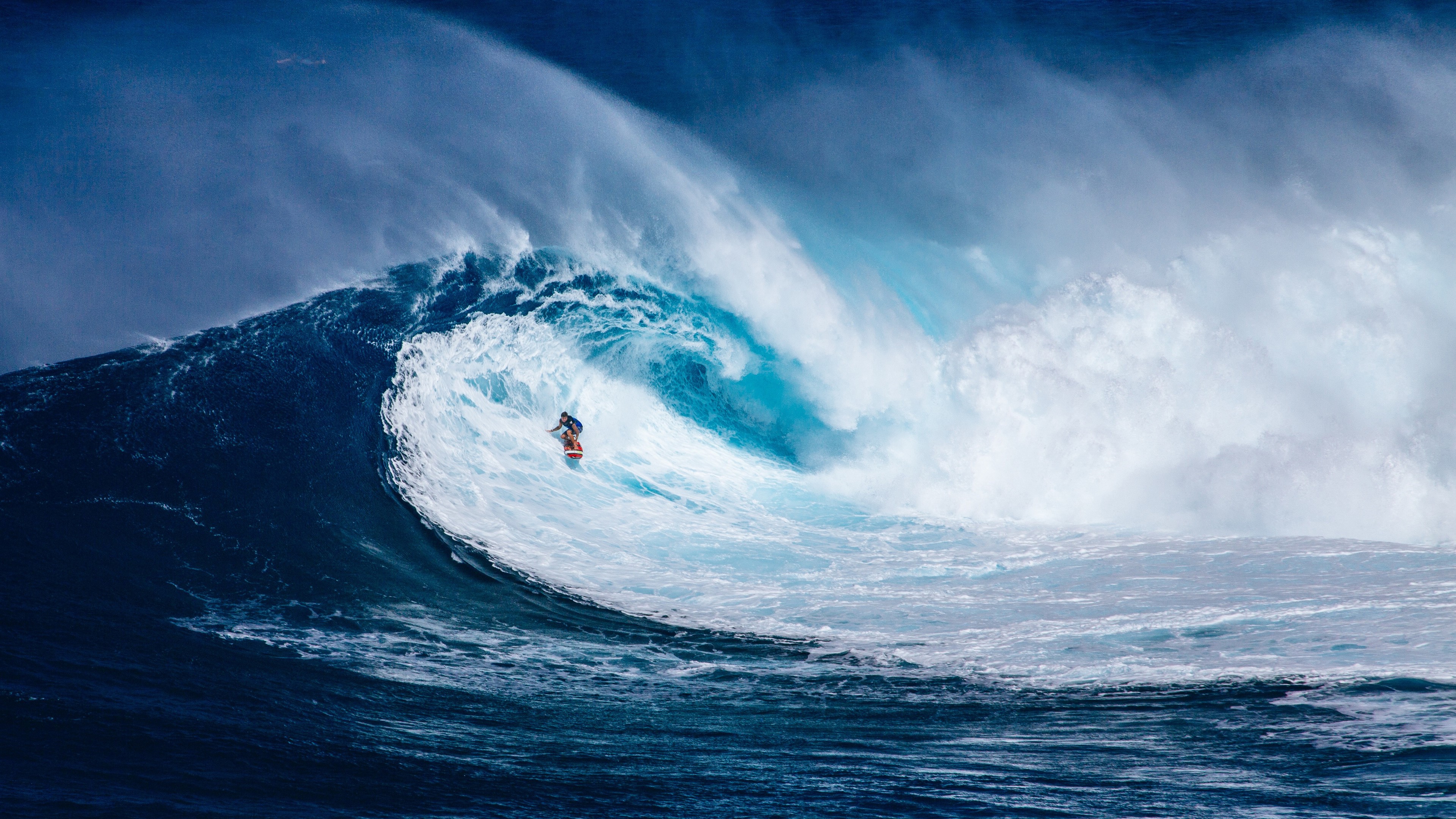 Surfer riding a giant wave in the ocean 4K HD Wallpaper