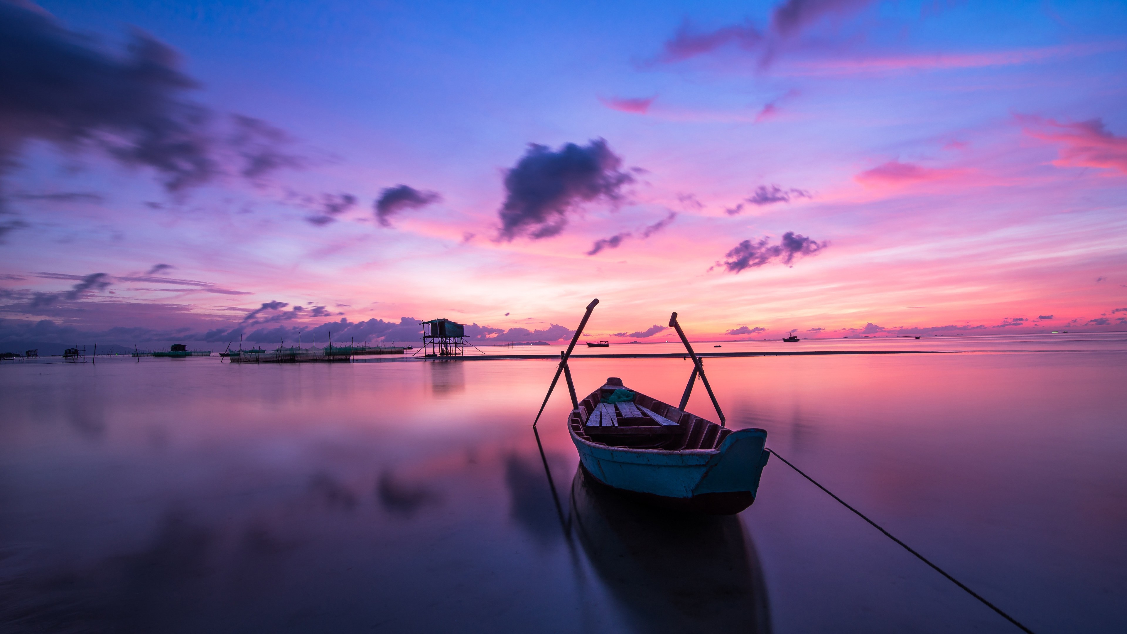 Boat on calm water during sunrise with colorful sky HD Wallpaper