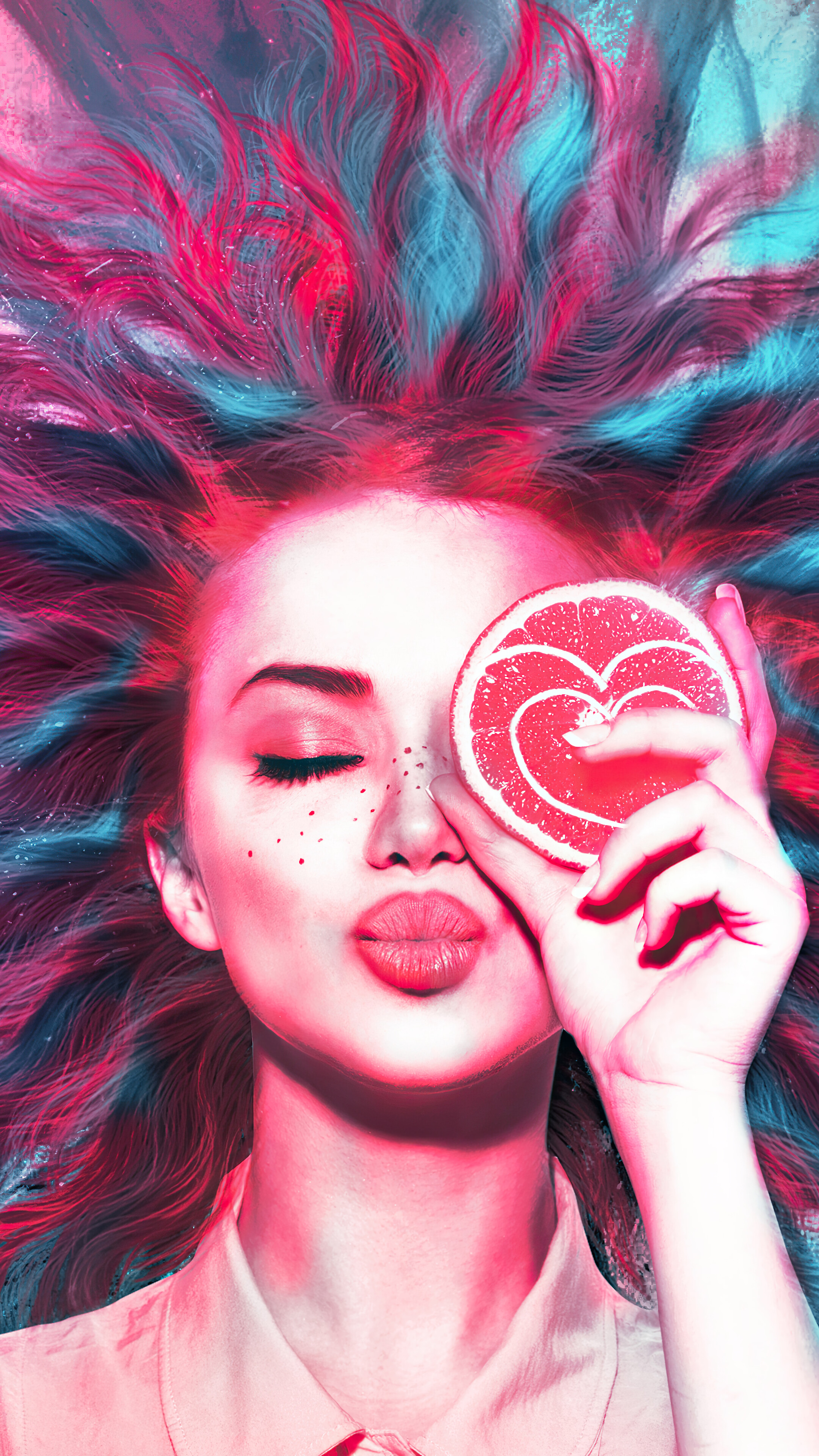 Girl with pink and blue hair holding grapefruit slice HD Phone Wallpaper