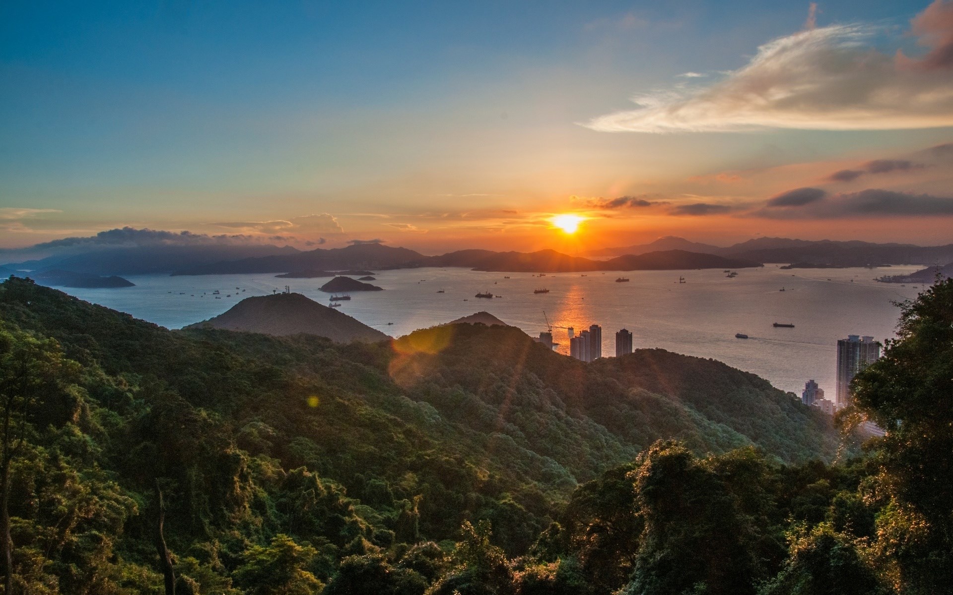 Sunset over a bay with islands and city skyline HD Wallpaper