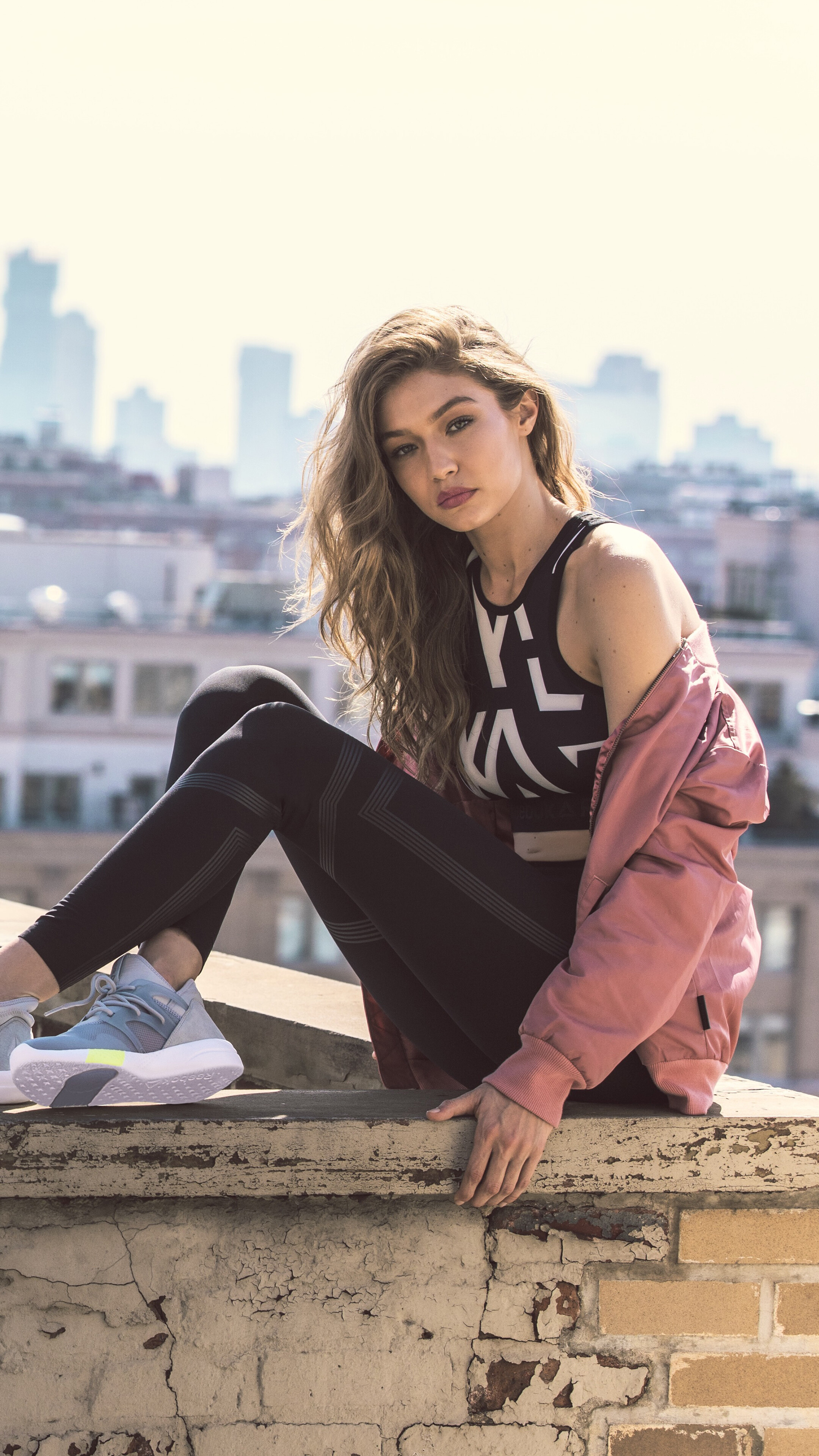 Gigi Hadid on a rooftop with city skyline HD Phone Wallpaper