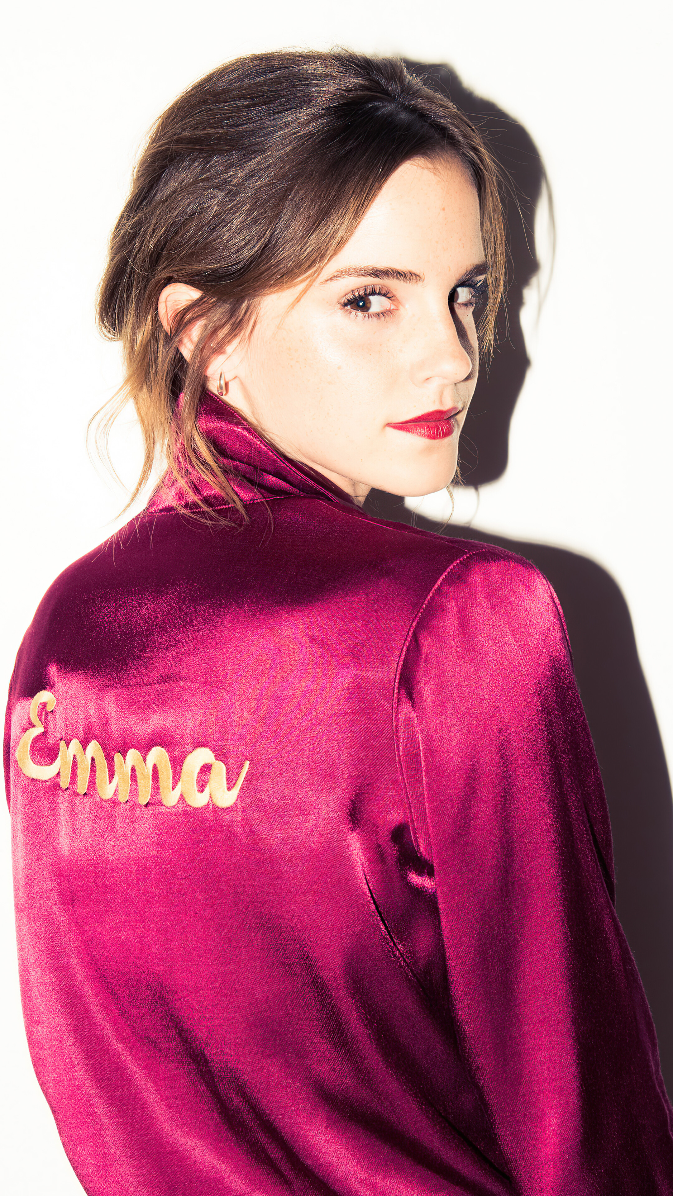 Emma Watson wearing a pink robe with 'Emma' embroidered HD Phone Wallpaper
