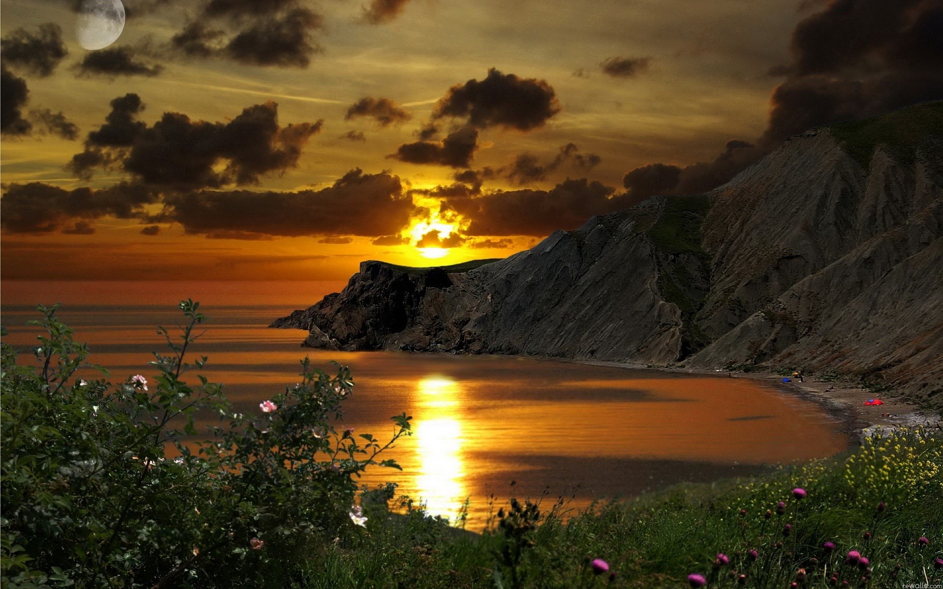 Sunset over a rocky coastline with a moon HD Wallpaper