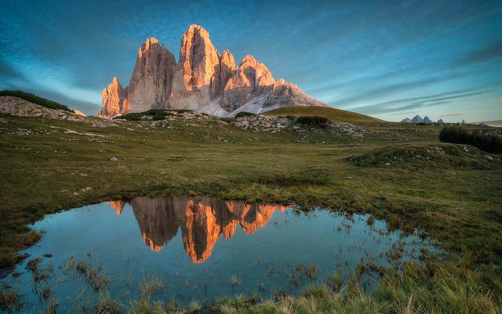 Tre Cime di Lavaredo reflected in a mountain pond HD Wallpaper