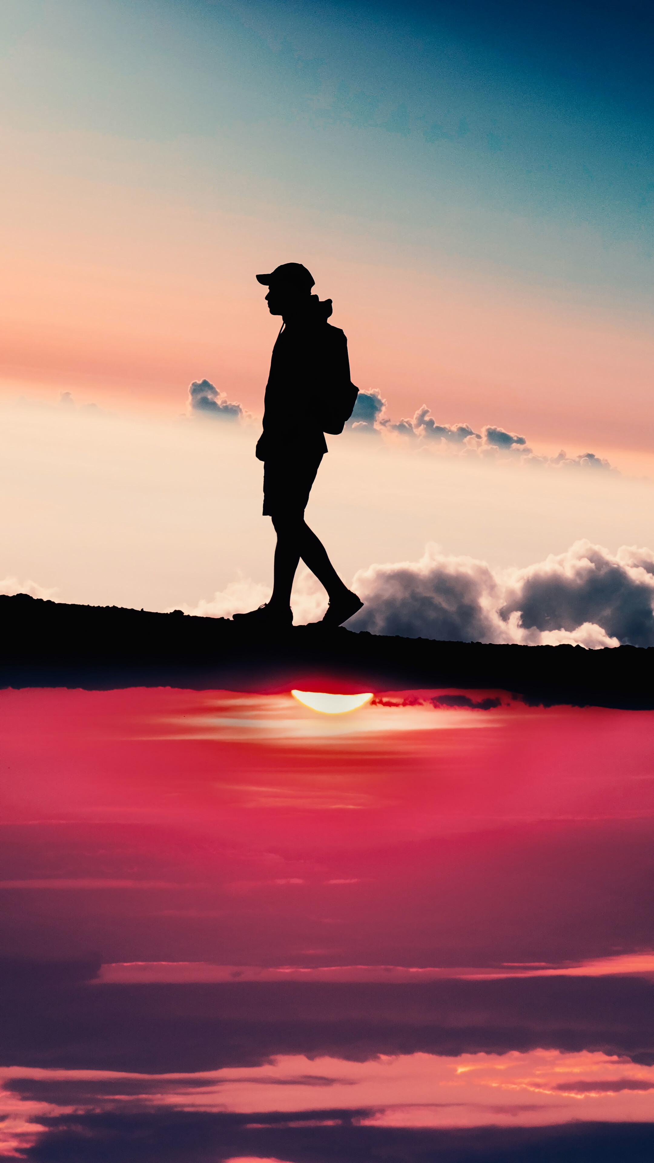 Silhouette of a person walking at sunset HD Phone Wallpaper