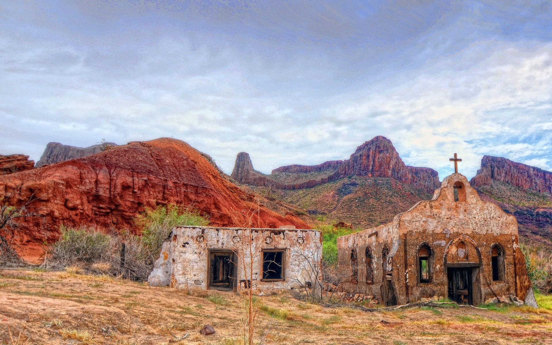 Ruined church and building in a desert landscape with mountains HD Wallpaper