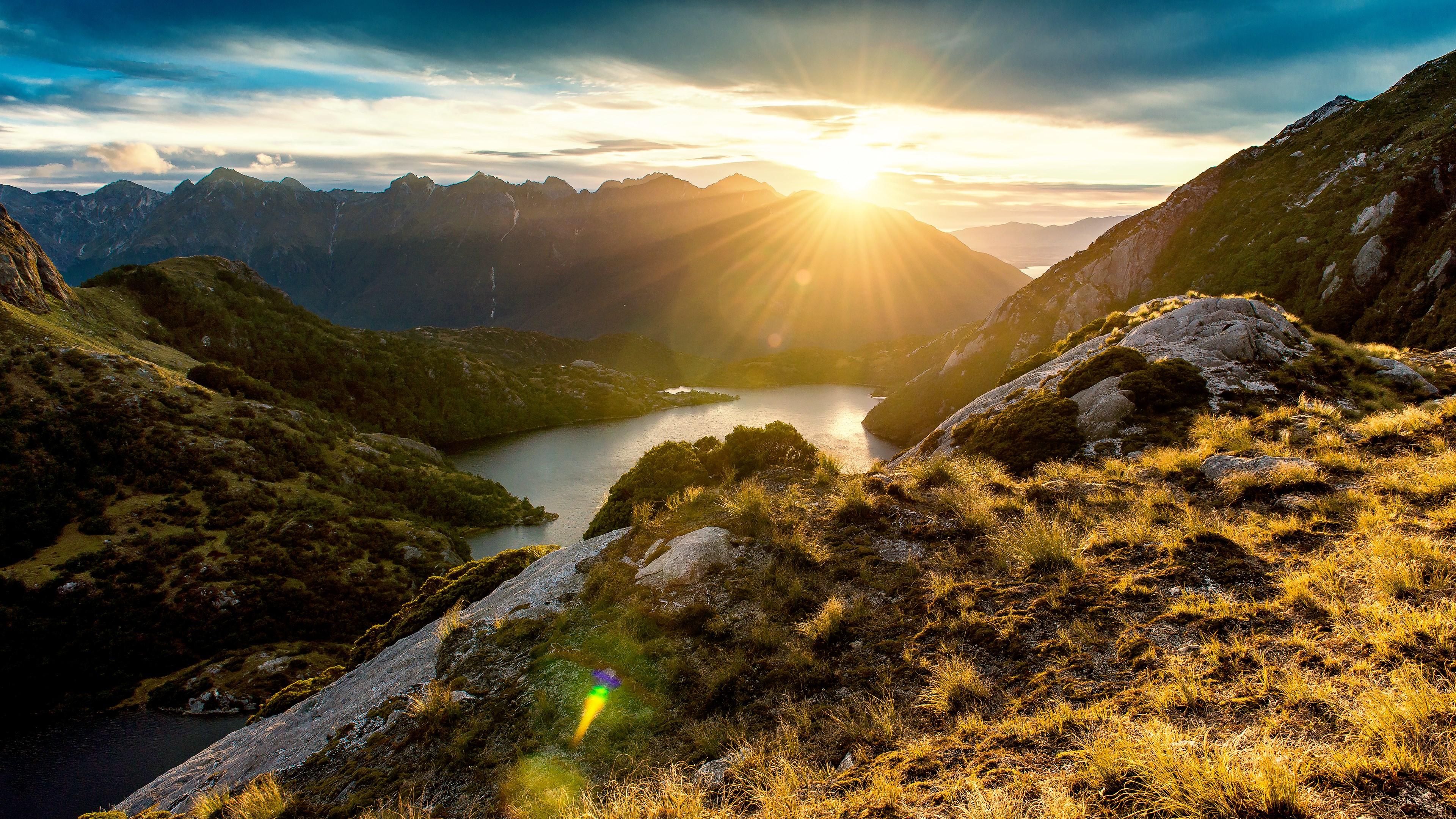 Sunrise over a mountain lake with sun rays HD Wallpaper