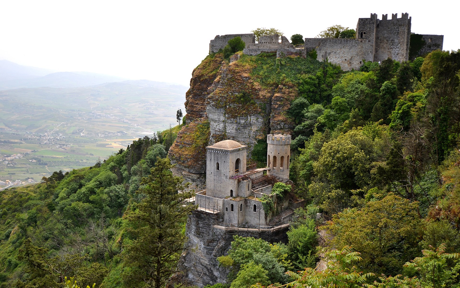 Castle on a cliff overlooking a valley HD Wallpaper