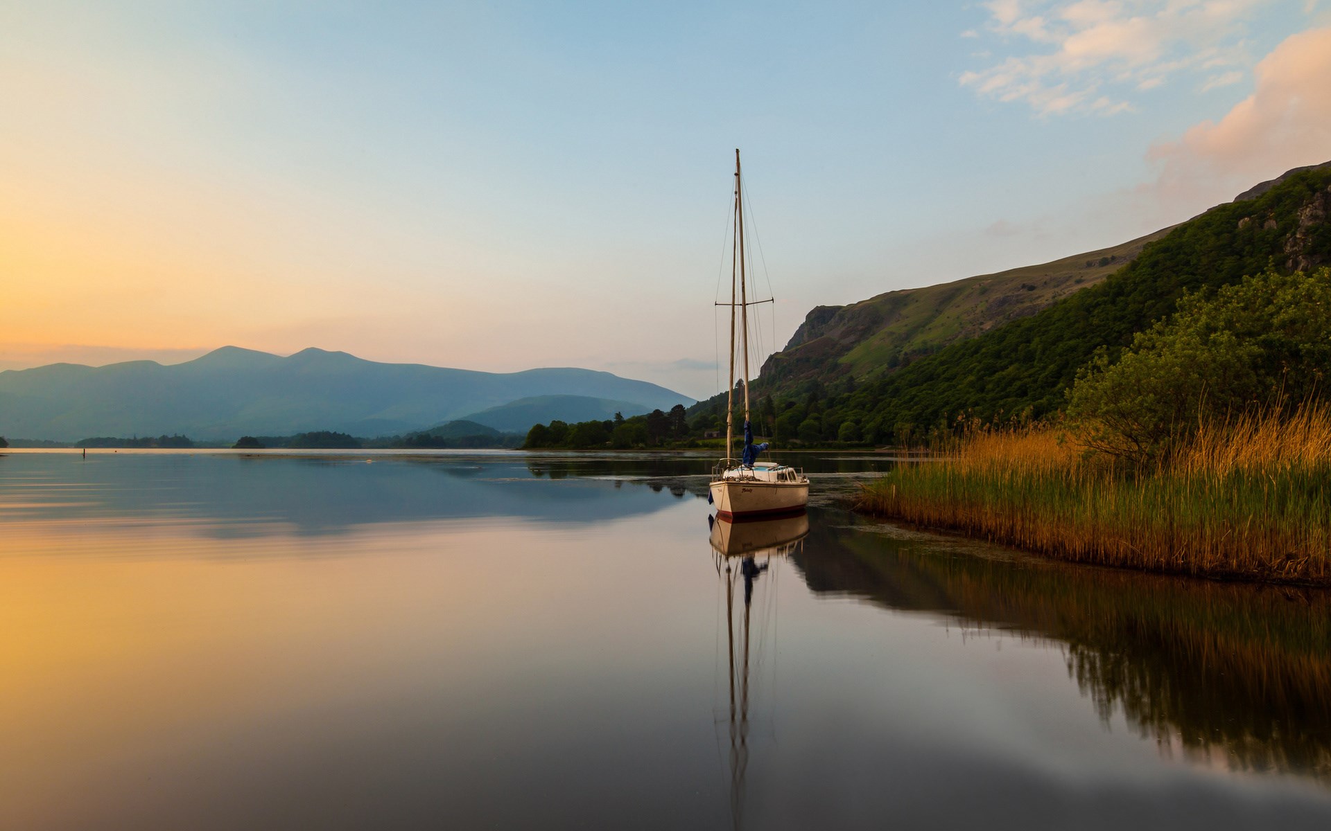 Sailboat on a calm lake at sunrise with mountains HD Wallpaper