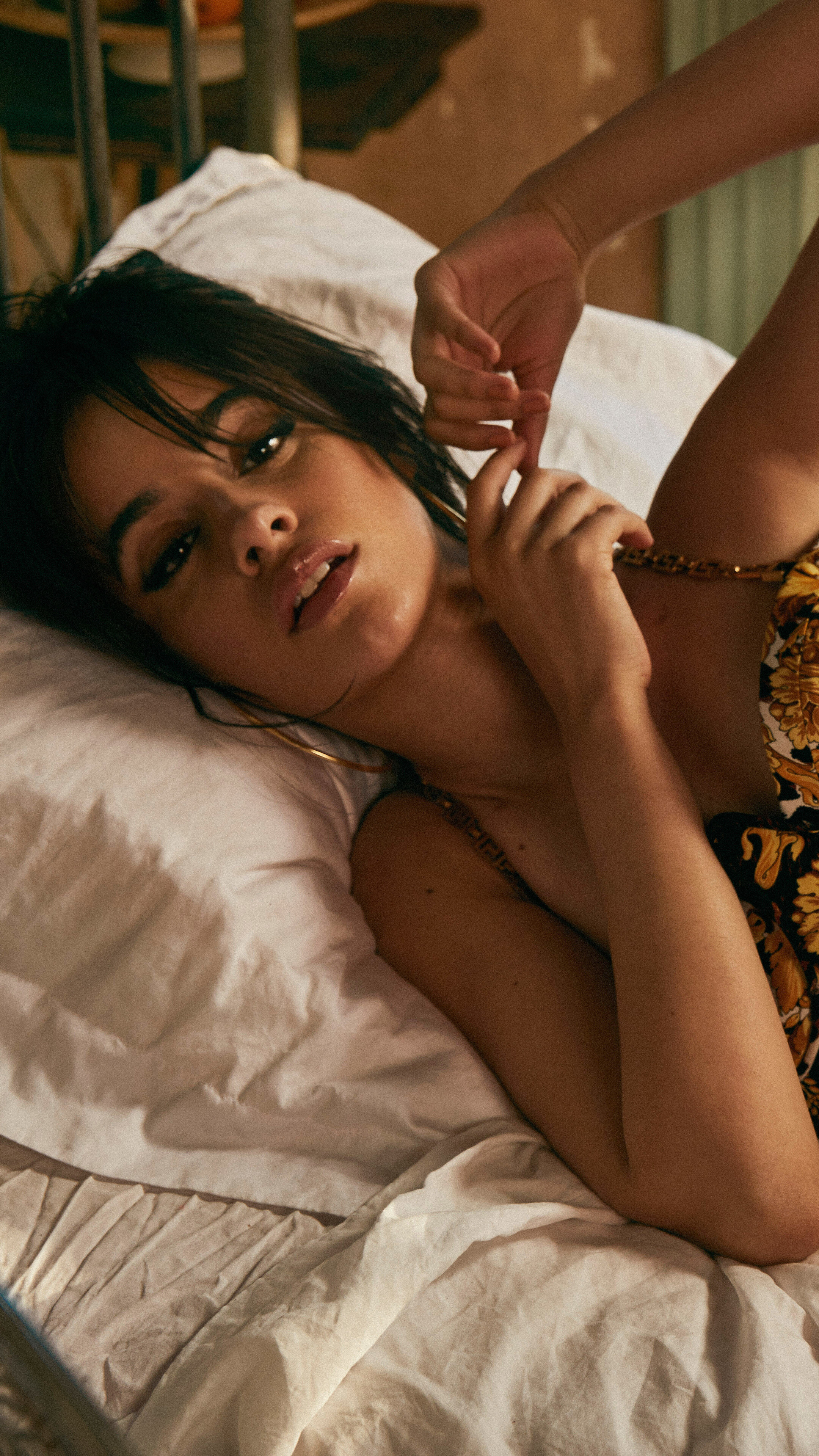 Camila Cabello lying on a bed HD Phone Wallpaper