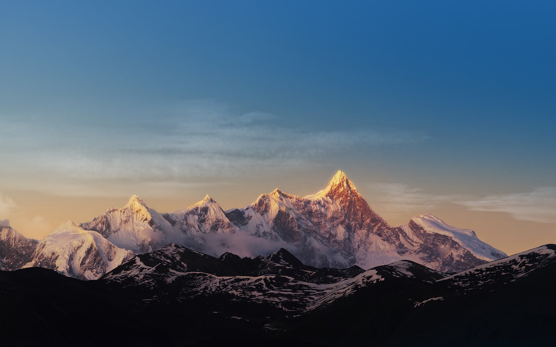 Snow-capped mountains at sunrise HD Wallpaper