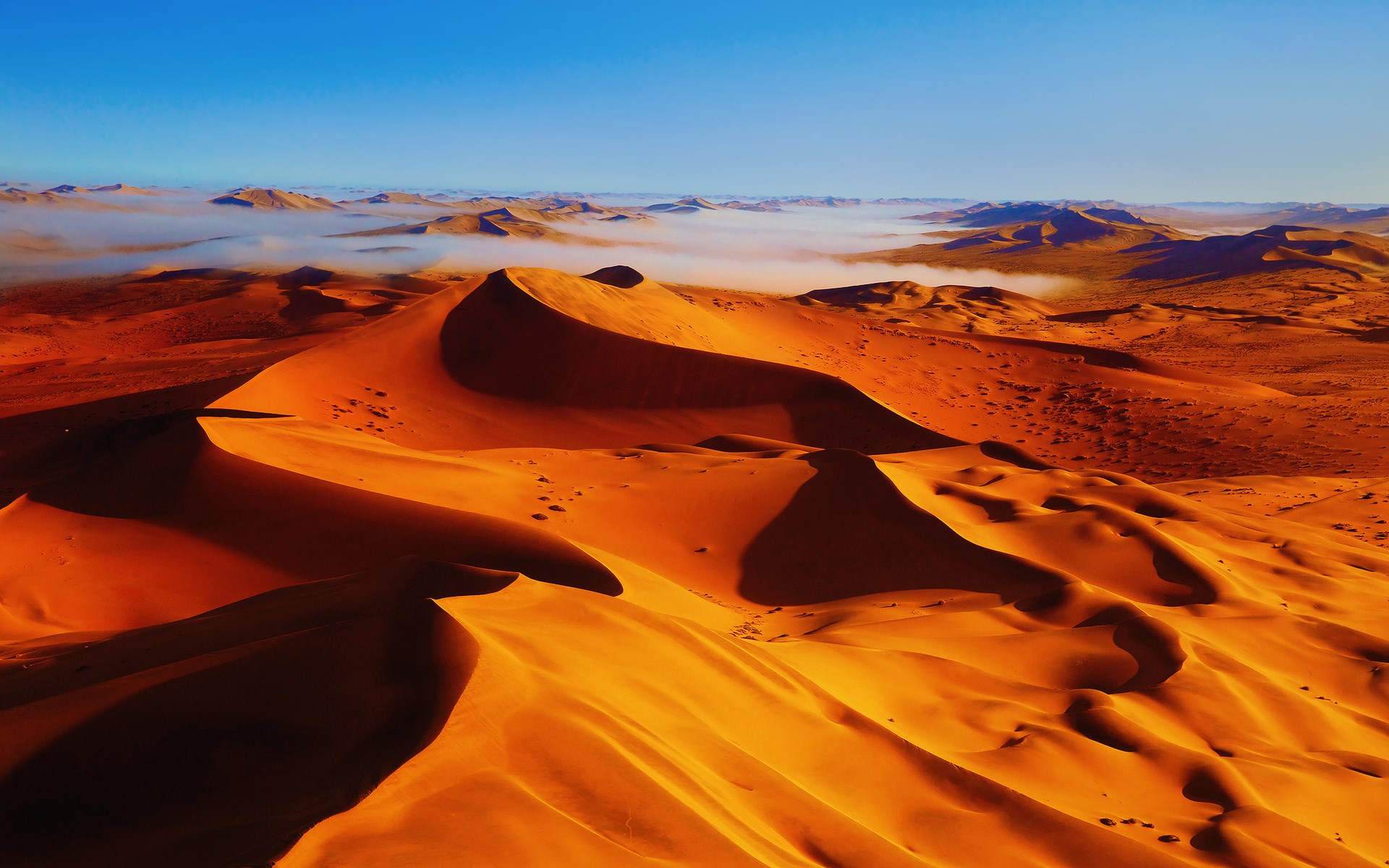 Desert sand dunes with fog and blue sky HD Wallpaper