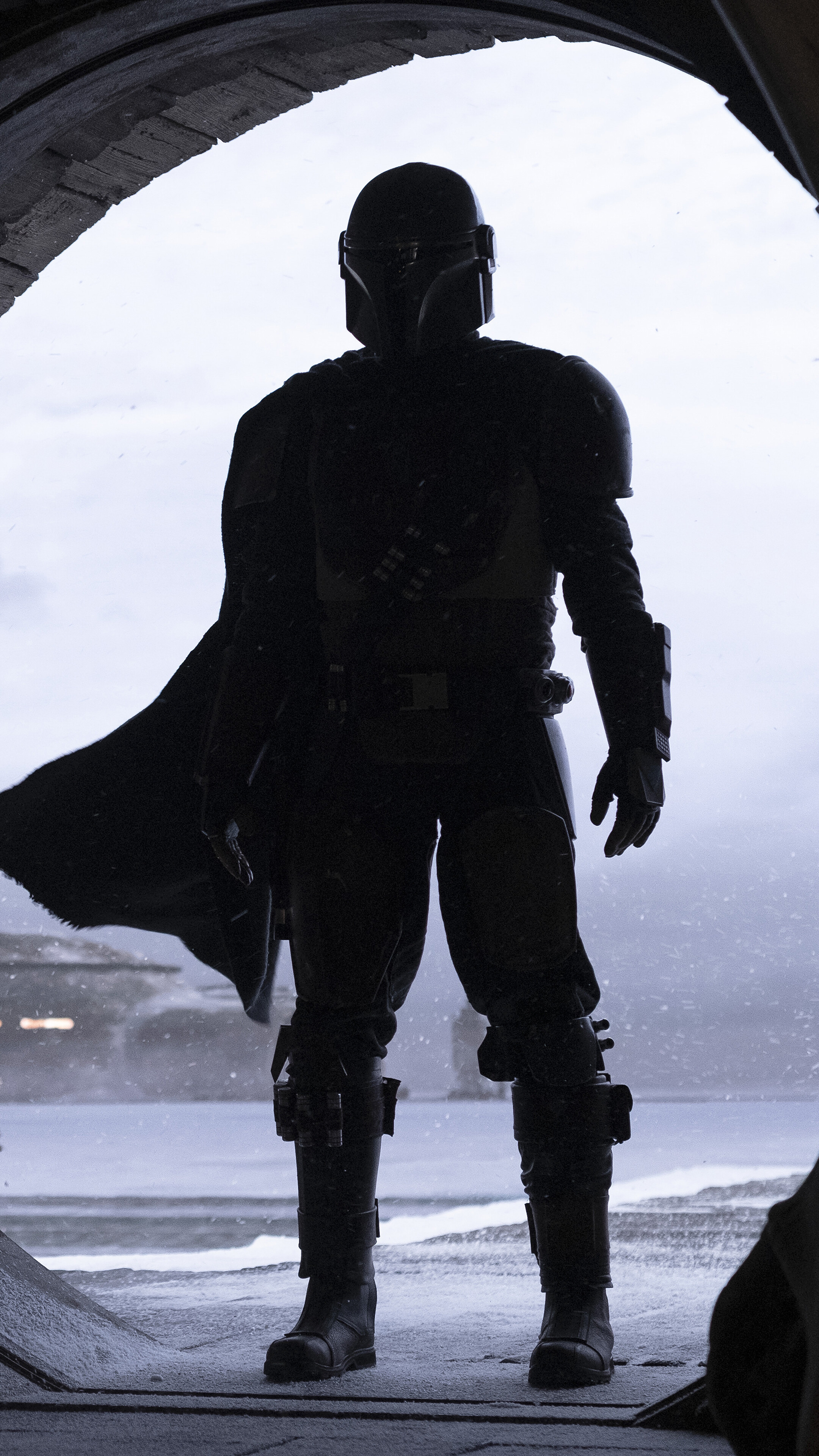 The Mandalorian in a snowy landscape HD Phone Wallpaper