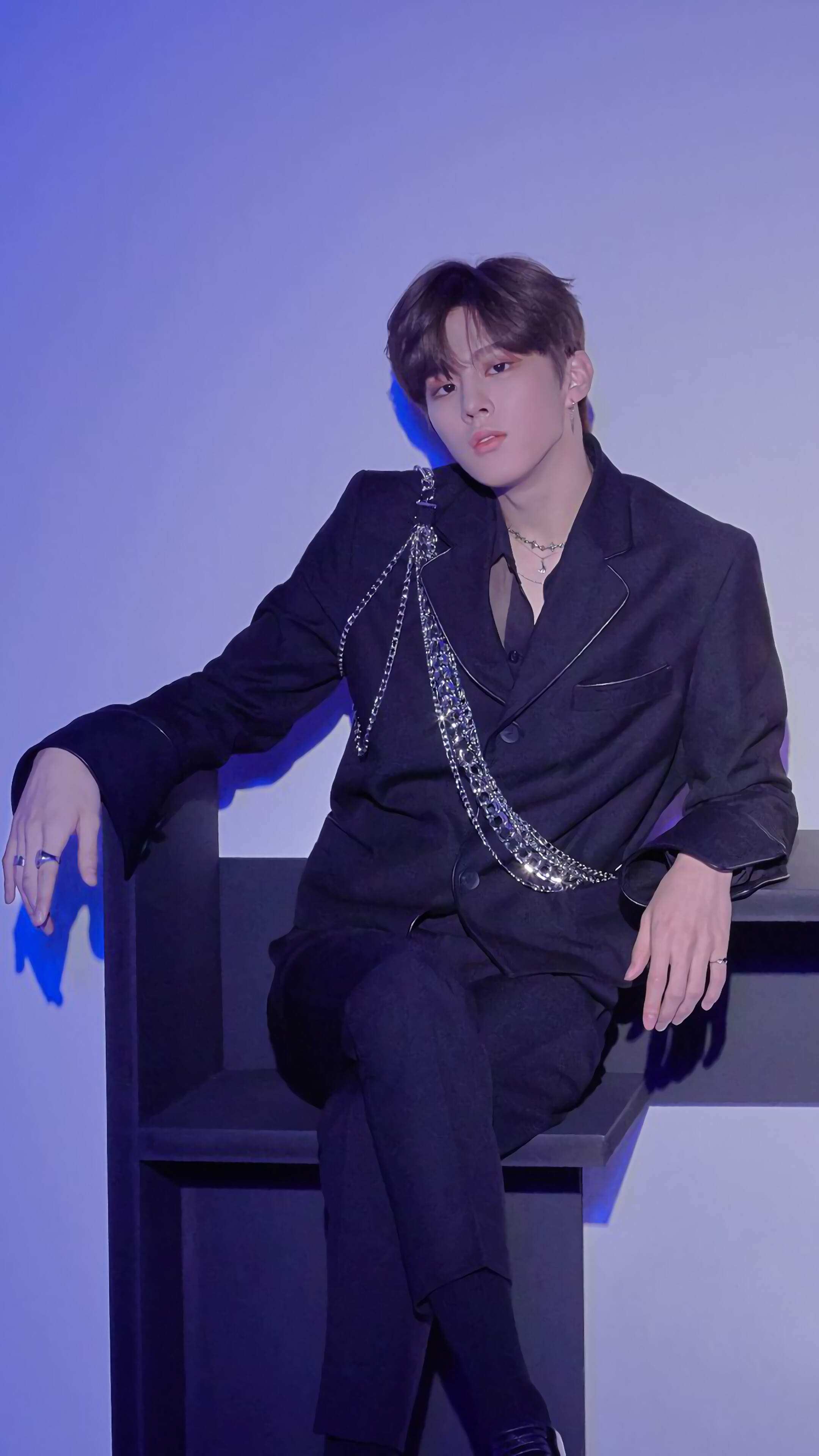 Wooseok in a black suit with chain detail HD Phone Wallpaper