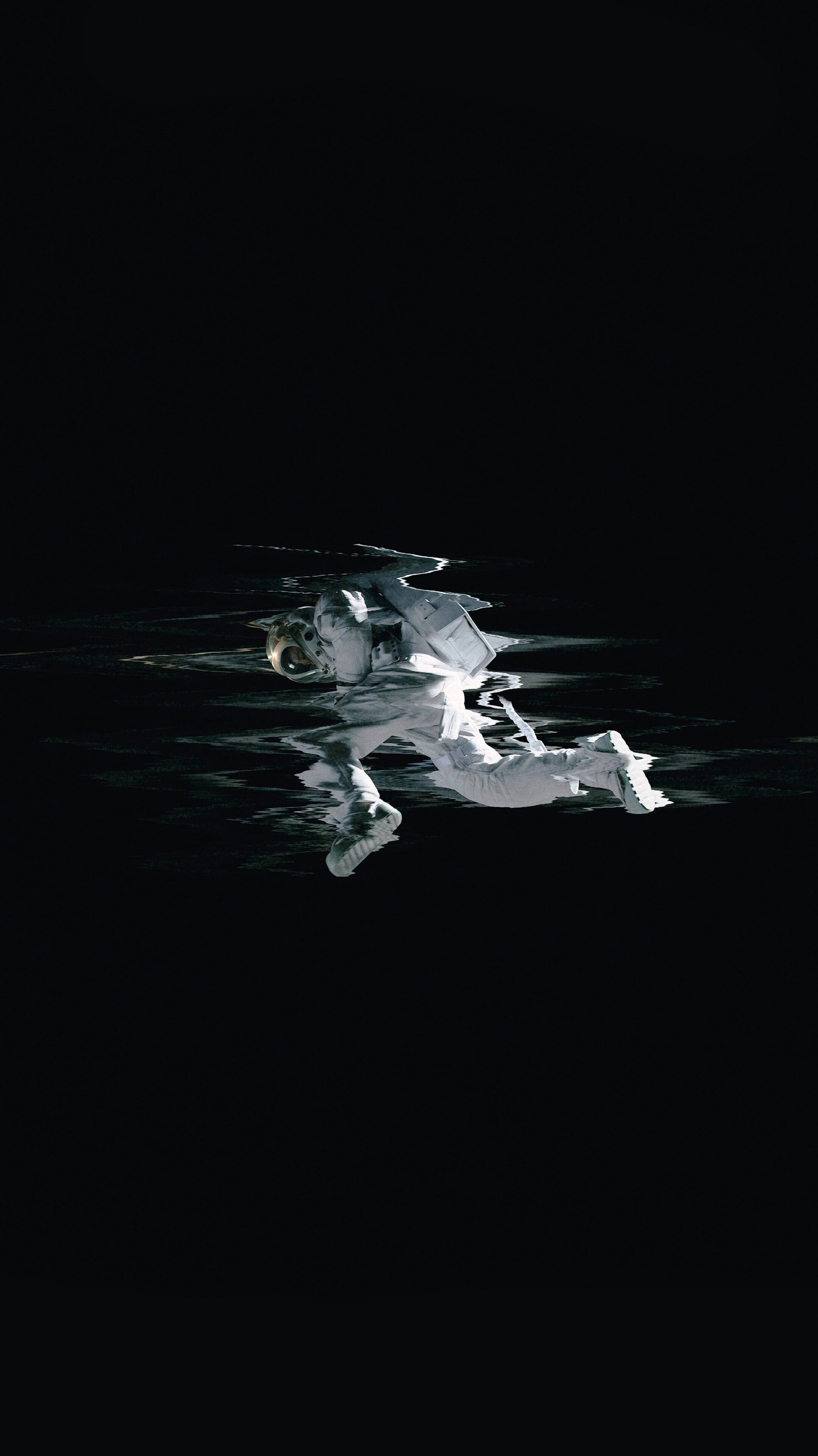 Astronaut floating in dark water HD Phone Wallpaper