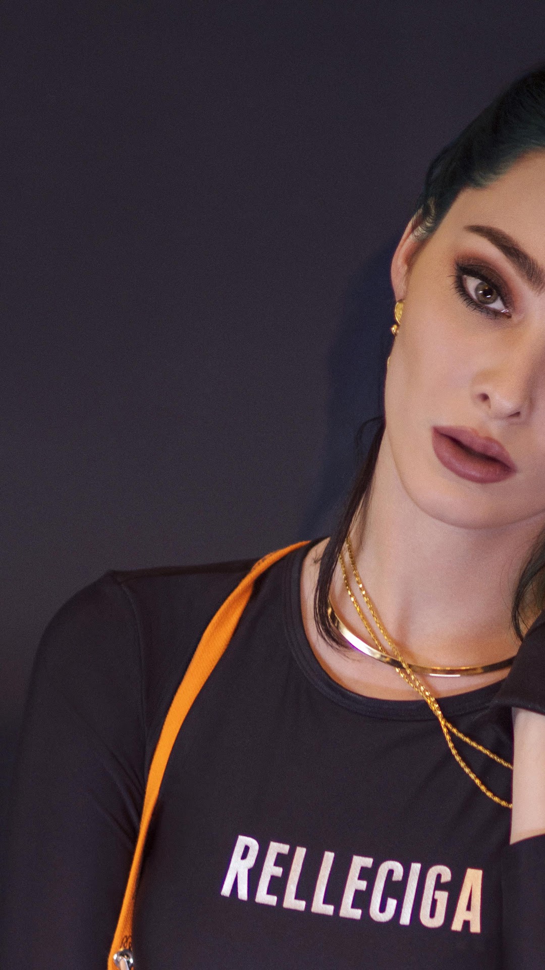 Emma Dumont wearing black top with orange strap HD Phone Wallpaper
