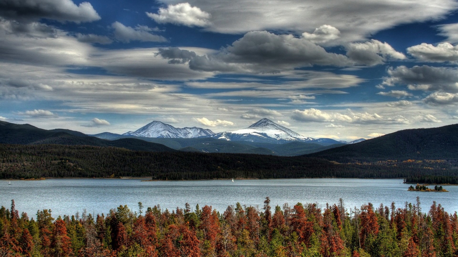 Lake and snow-capped mountains under a cloudy sky HD Wallpaper