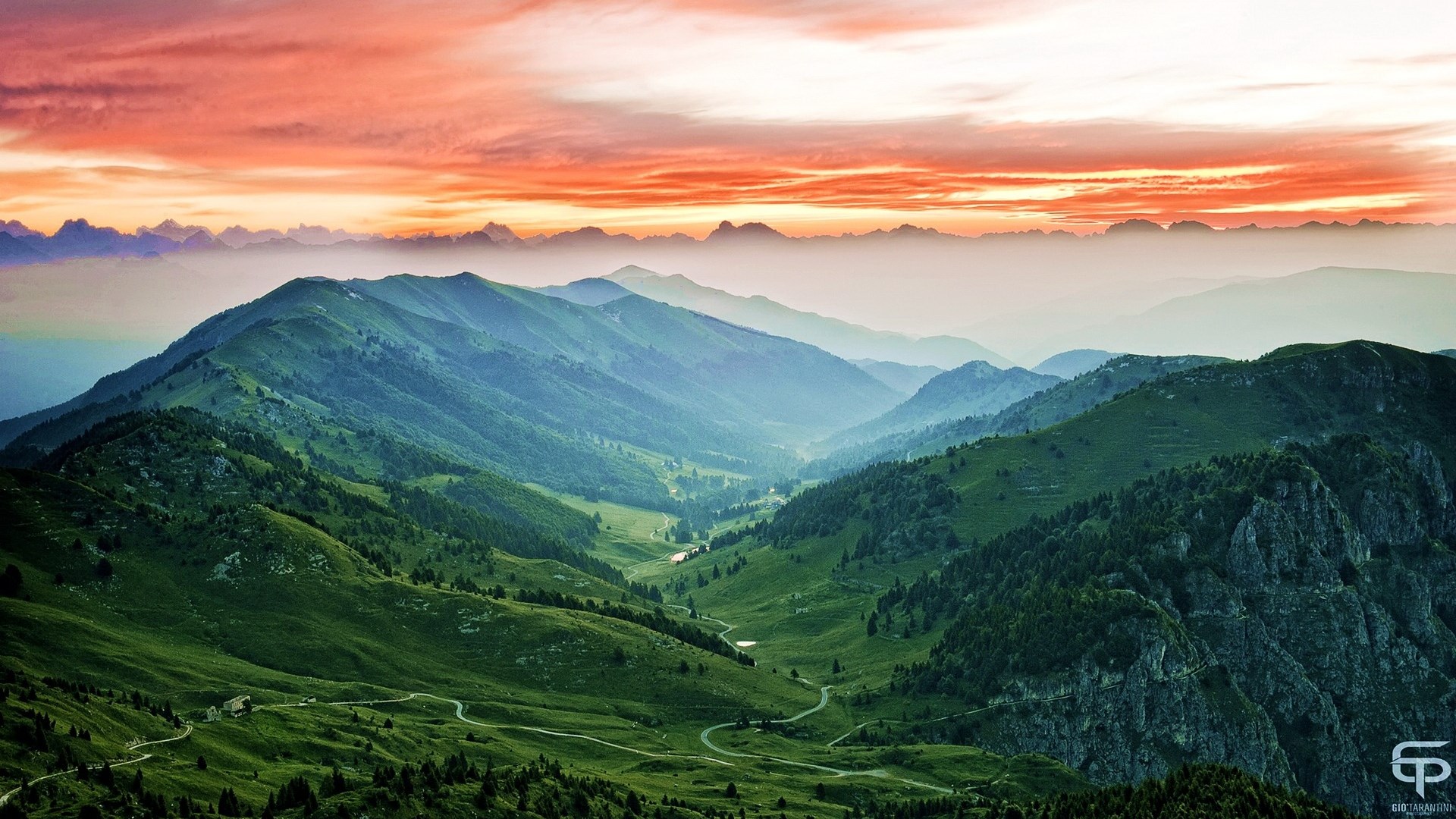 Mountain range at sunset with orange sky HD Wallpaper