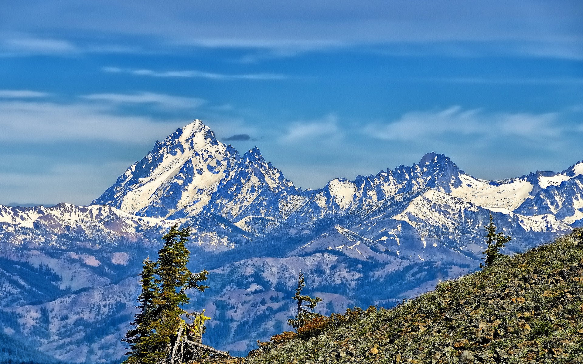 Snow-capped mountains under a blue sky HD Wallpaper