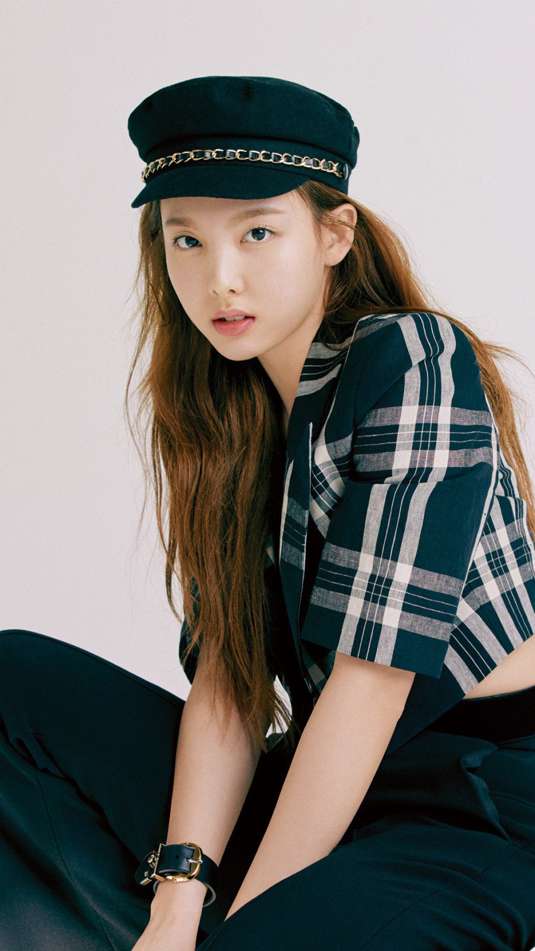Nayeon from TWICE wearing a hat and plaid jacket HD Phone Wallpaper