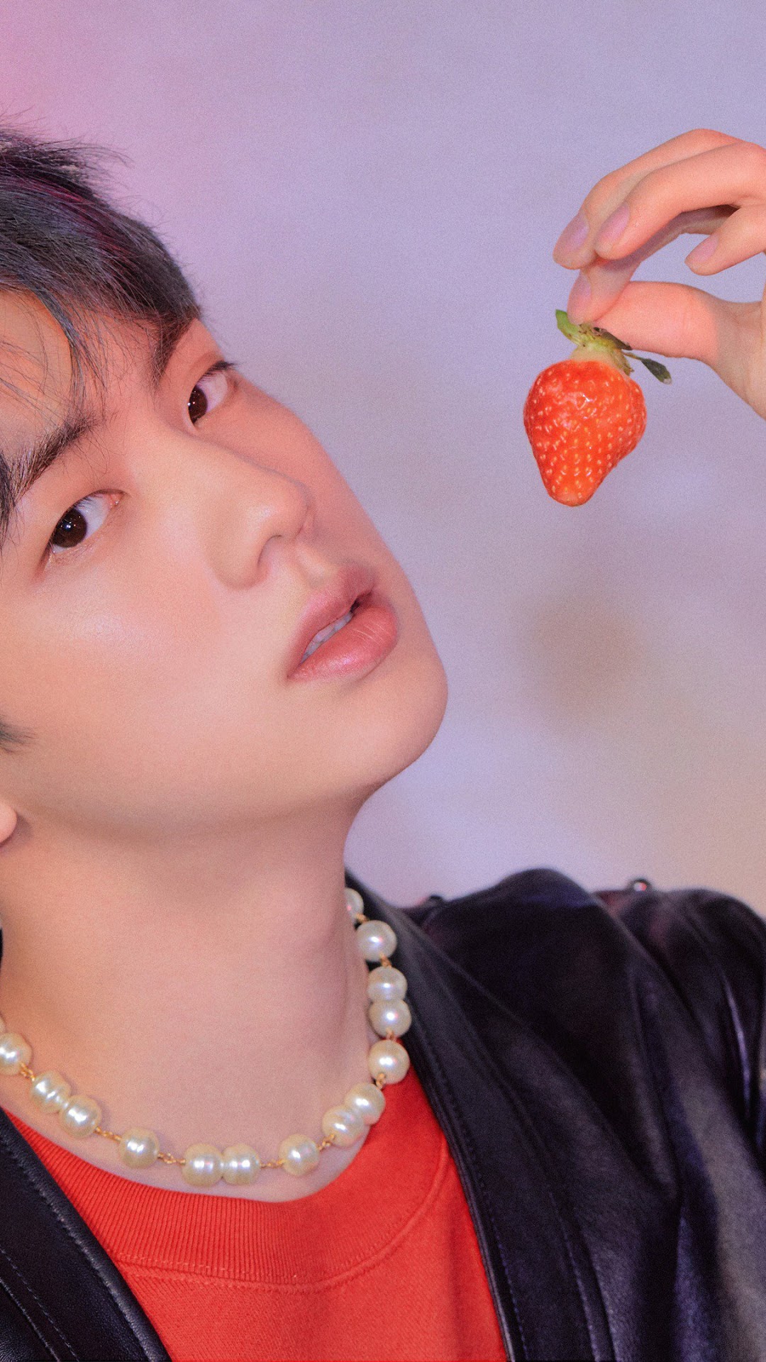 Jin from BTS holding a strawberry HD Phone Wallpaper