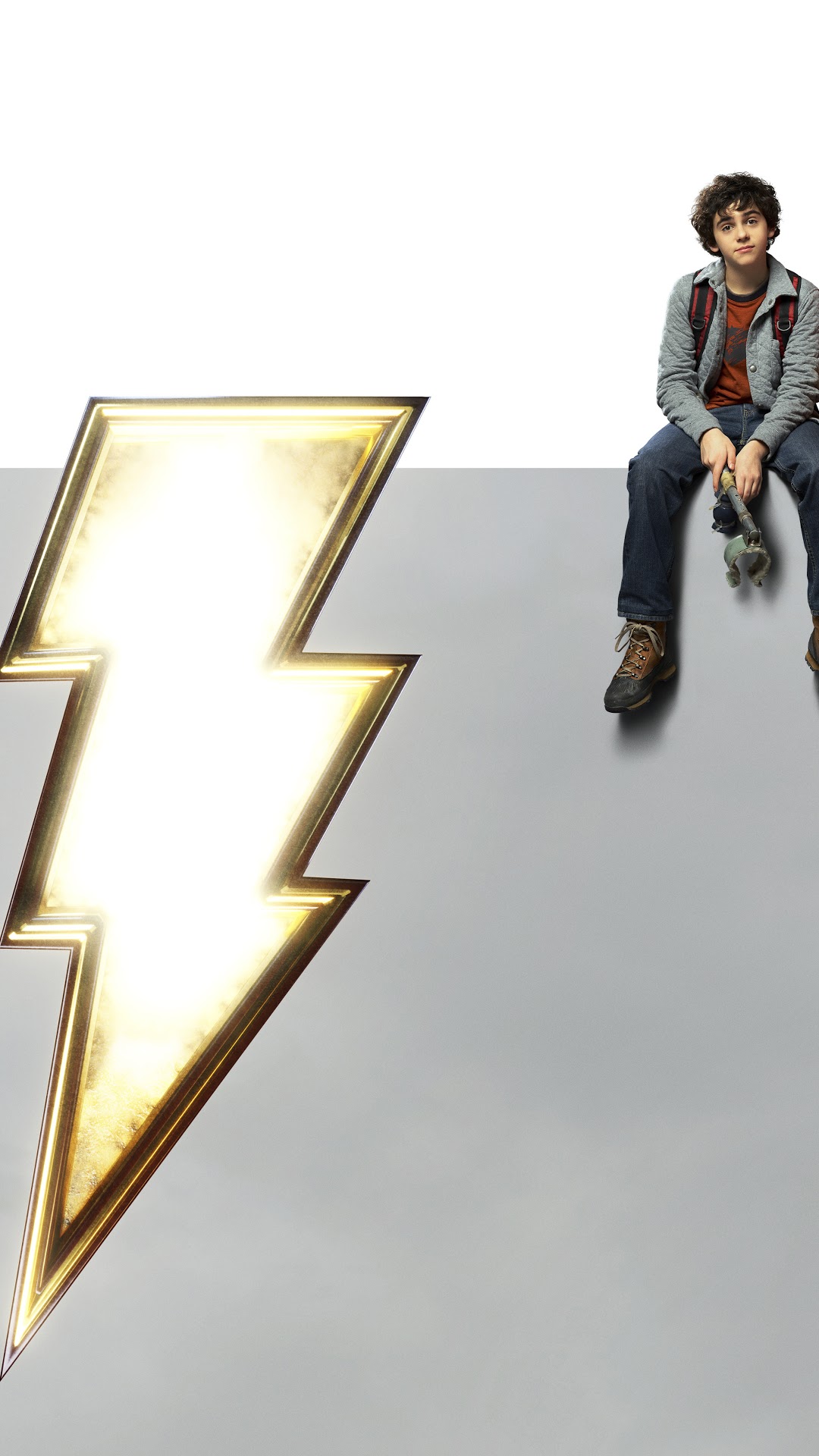 Billy Batson from Shazam sitting next to lightning bolt logo HD Phone Wallpaper