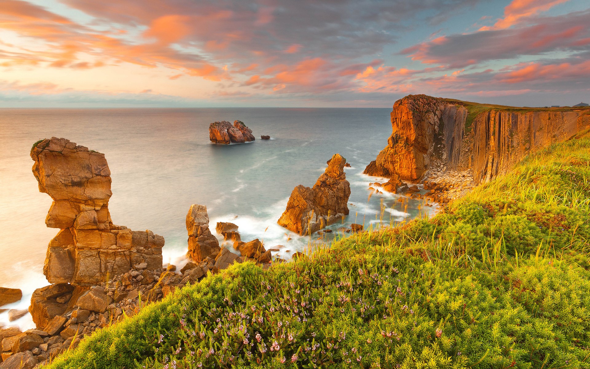 Rocky coastline with sea stacks at sunset HD Wallpaper