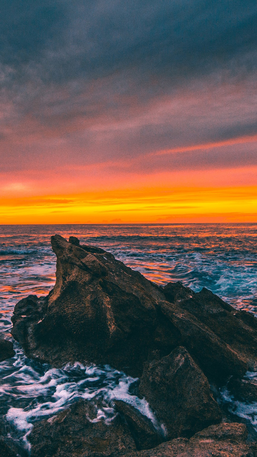 Sunset over the ocean with rocks HD Phone Wallpaper