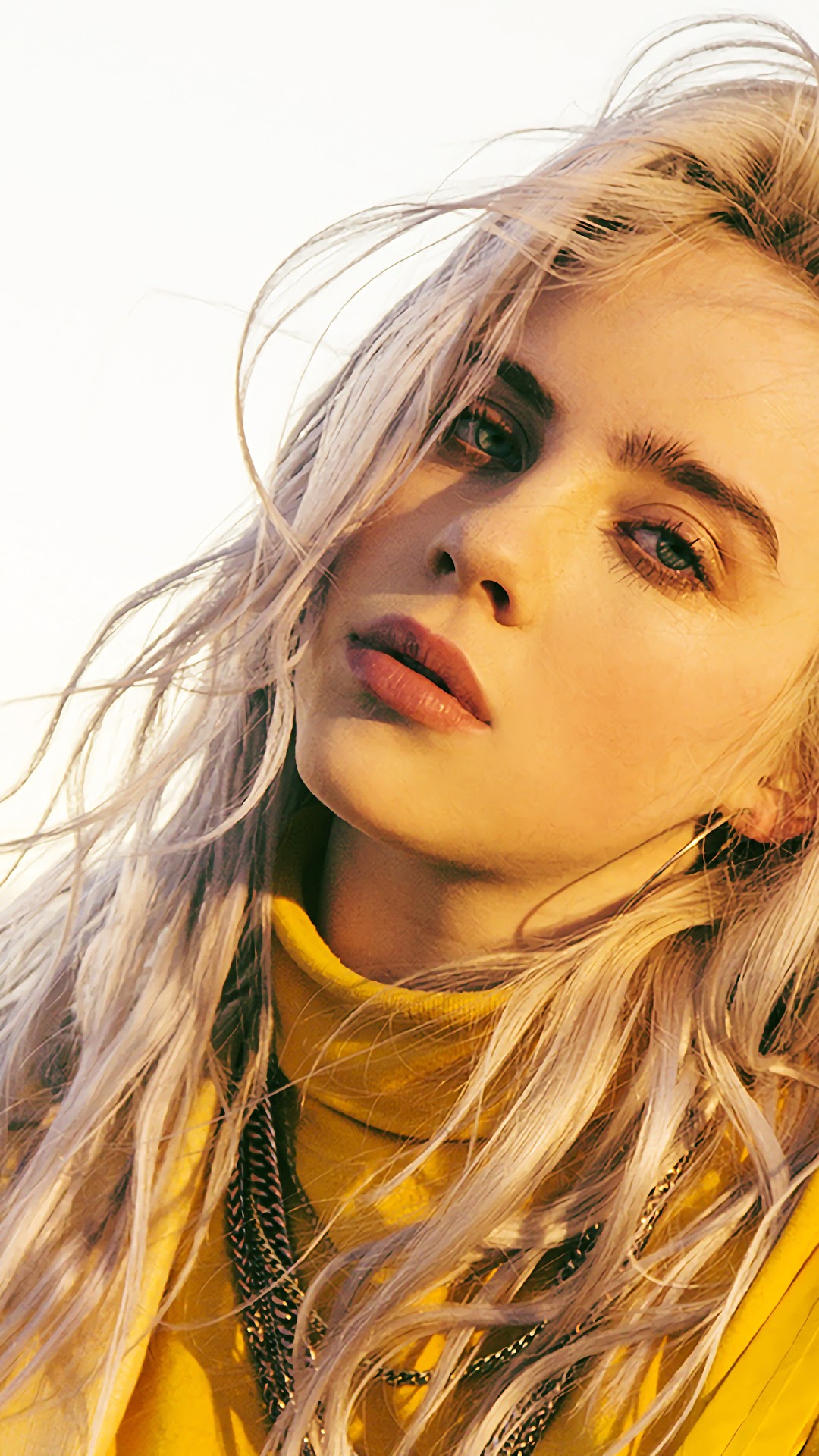 Billie Eilish with blonde hair wearing a yellow turtleneck HD Phone Wallpaper