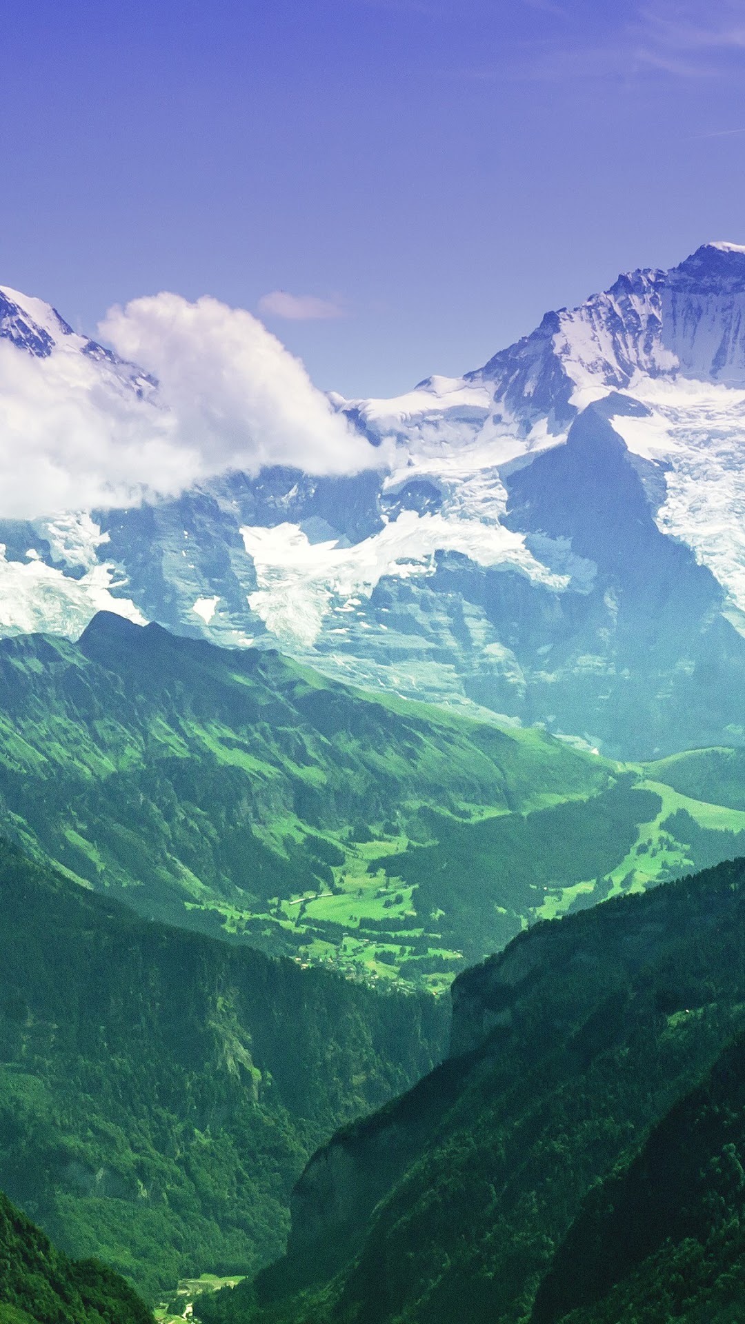 Snow-capped mountains and green valleys under a blue sky HD Phone Wallpaper