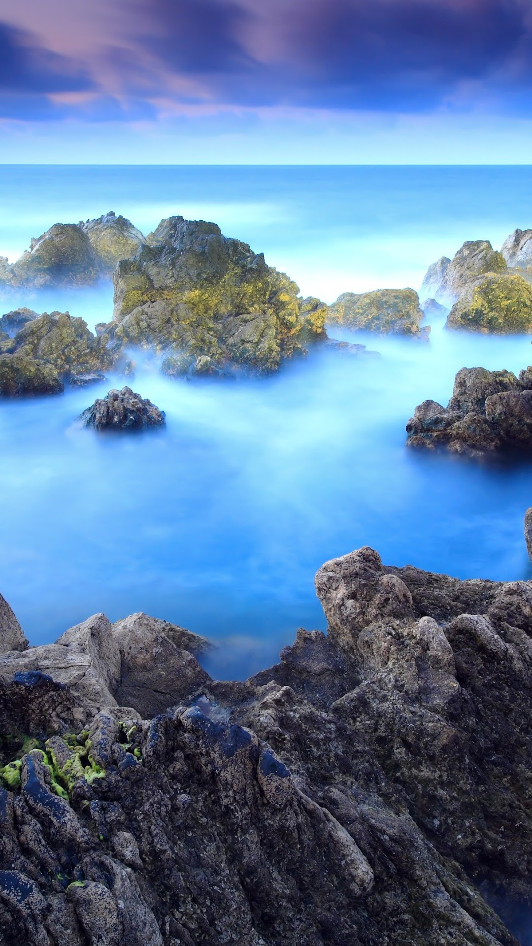 Rocky Seascape with Foggy Water and Purple Clouds HD Phone Wallpaper