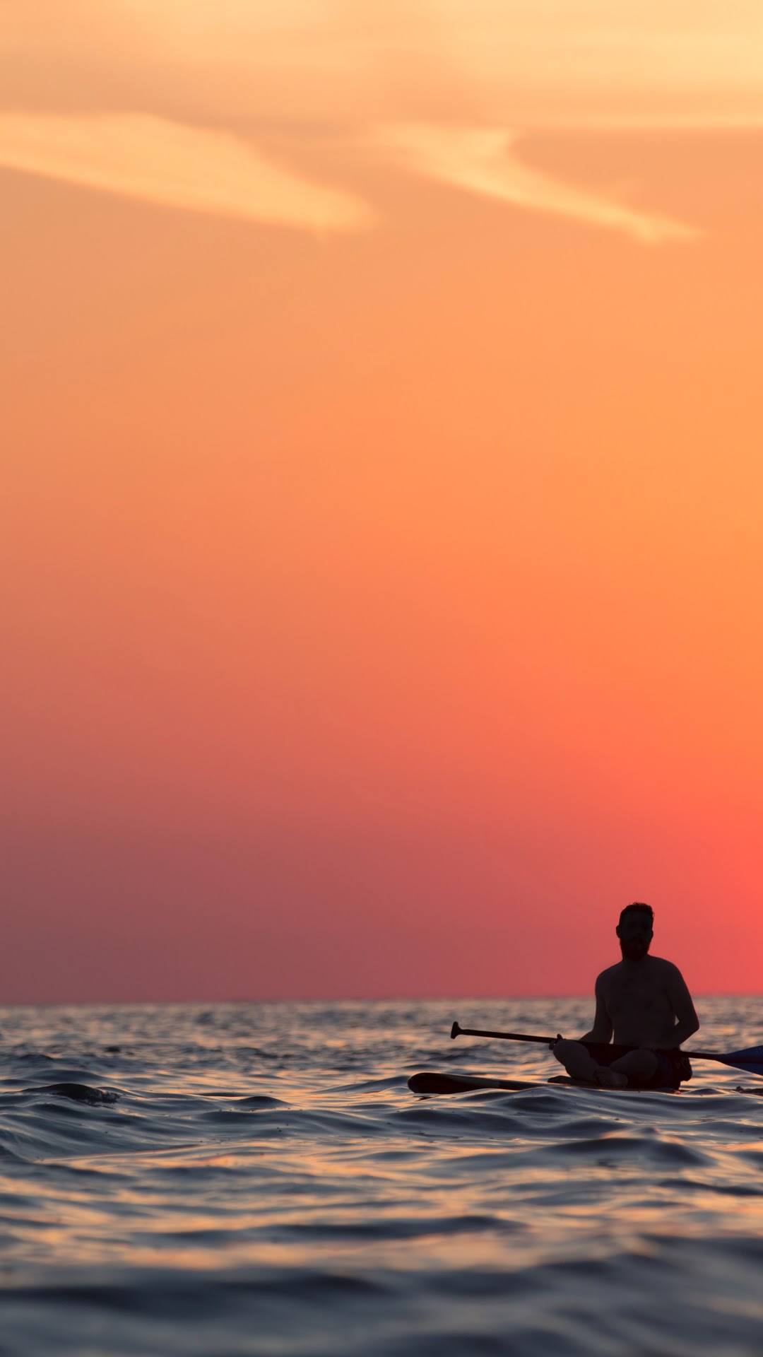 Man meditating on a paddleboard at sunset HD Phone Wallpaper